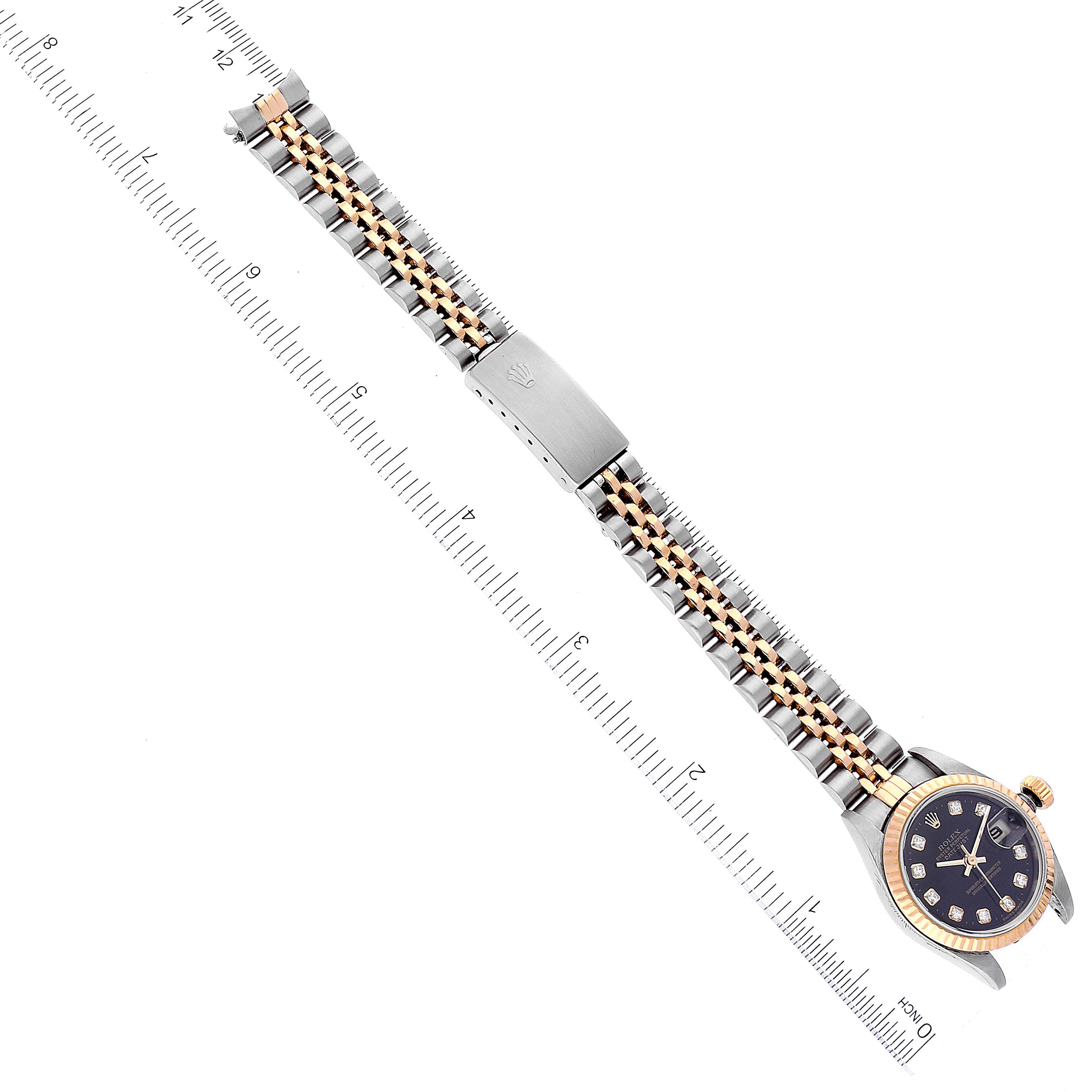 The image shows the Rolex Datejust 79173 Women's Steel and Gold (two tone) Black Dial 79173 Women's Steel and Gold (two tone) Black Dial watch laid flat with its face, bezel, crown, and the full length of its Jubilee bracelet visible.