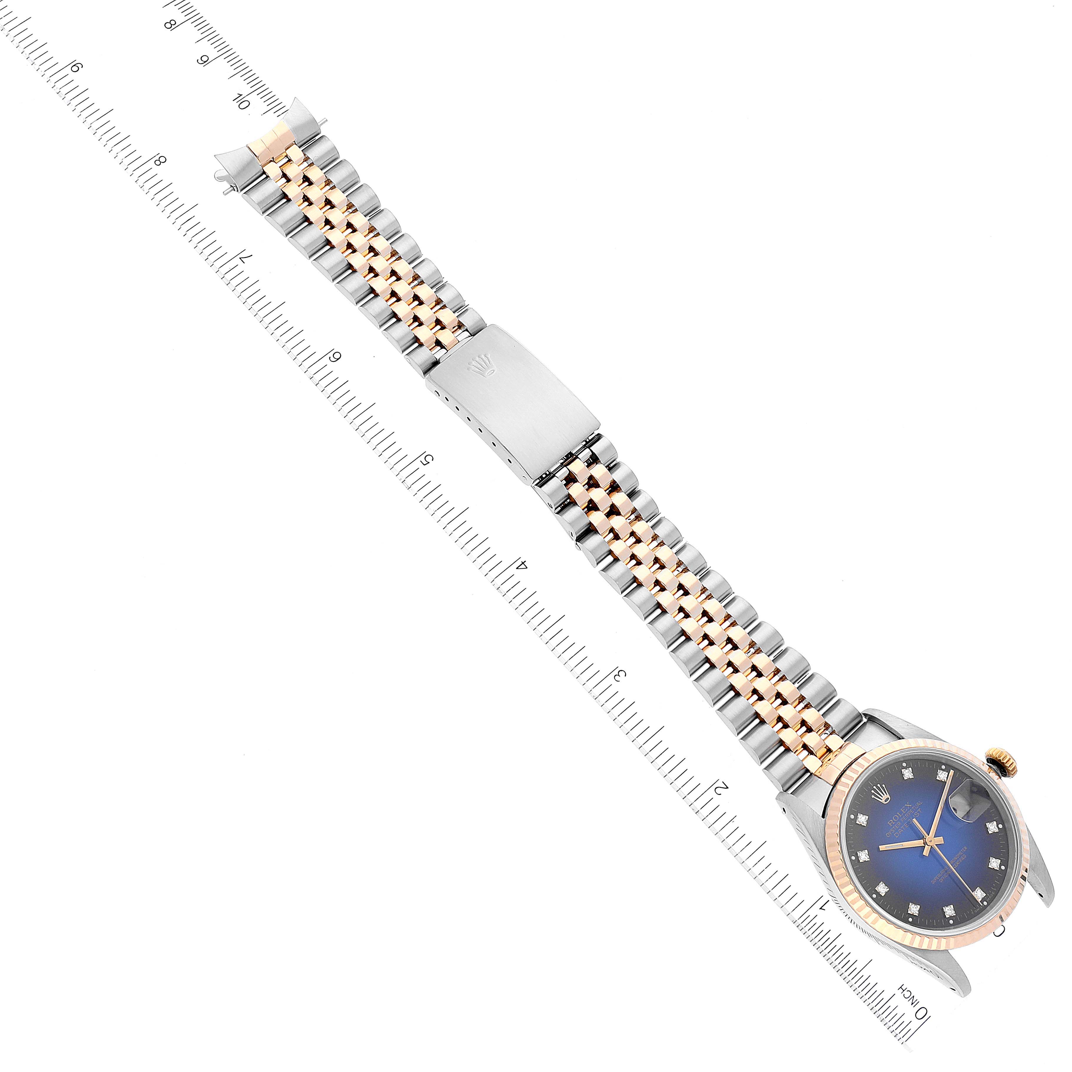 The image shows a Rolex Datejust 16233 Men's Steel and Gold (two tone) Blue Dial 16233 Men's Steel and Gold (two tone) Blue Dial watch at an angled top view, highlighting its band, clasp, and face.