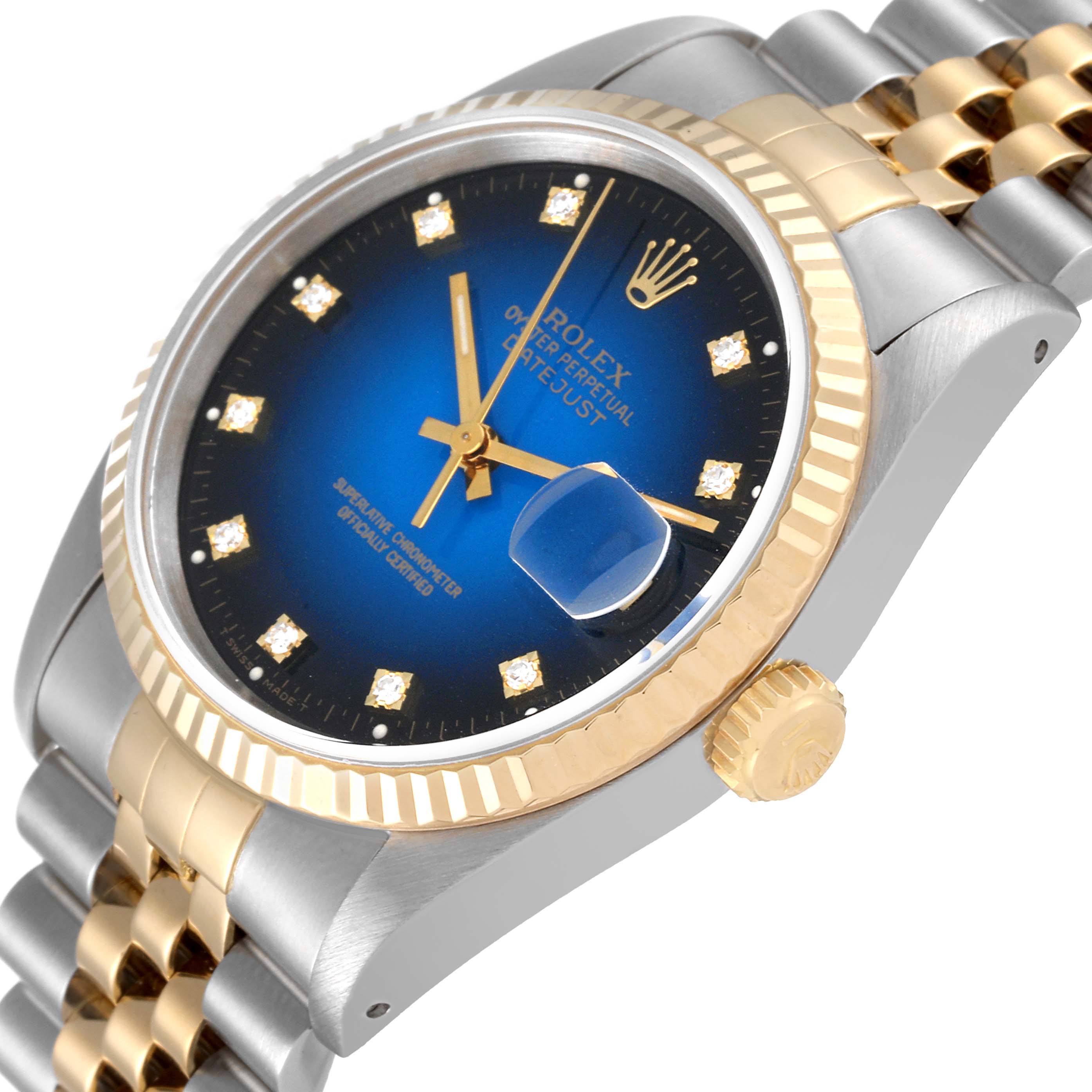 This image shows a Rolex Datejust 16233 Men's Steel and Gold (two tone) Blue Dial 16233 Men's Steel and Gold (two tone) Blue Dial watch at an angled view, highlighting its blue dial, fluted bezel, crown, and two-tone Jubilee bracelet.