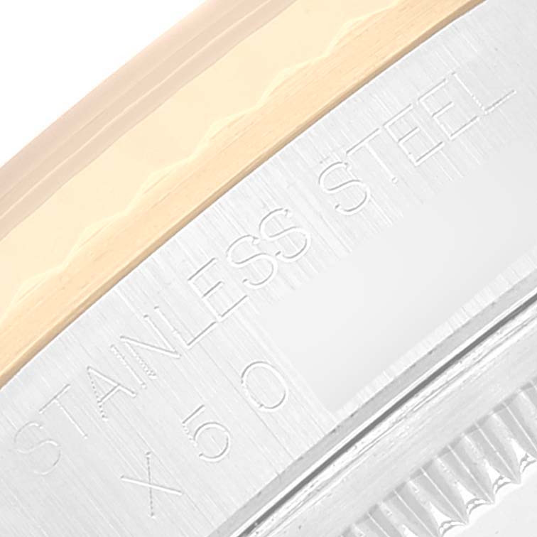 This image shows a close-up of the stainless steel and gold bezel with inscriptions on the Rolex Datejust 16233 Men's Steel and Gold (two tone) Blue Dial 16233 Men's Steel and Gold (two tone) Blue Dial model watch.