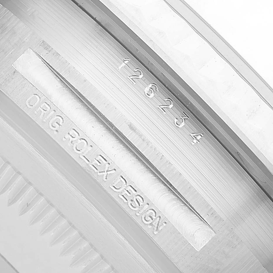 The image shows the side of the Rolex Datejust 126234 Men's Stainless Steel Grey Dial watch case with engraved model number and "ORIG ROLEX DESIGN."