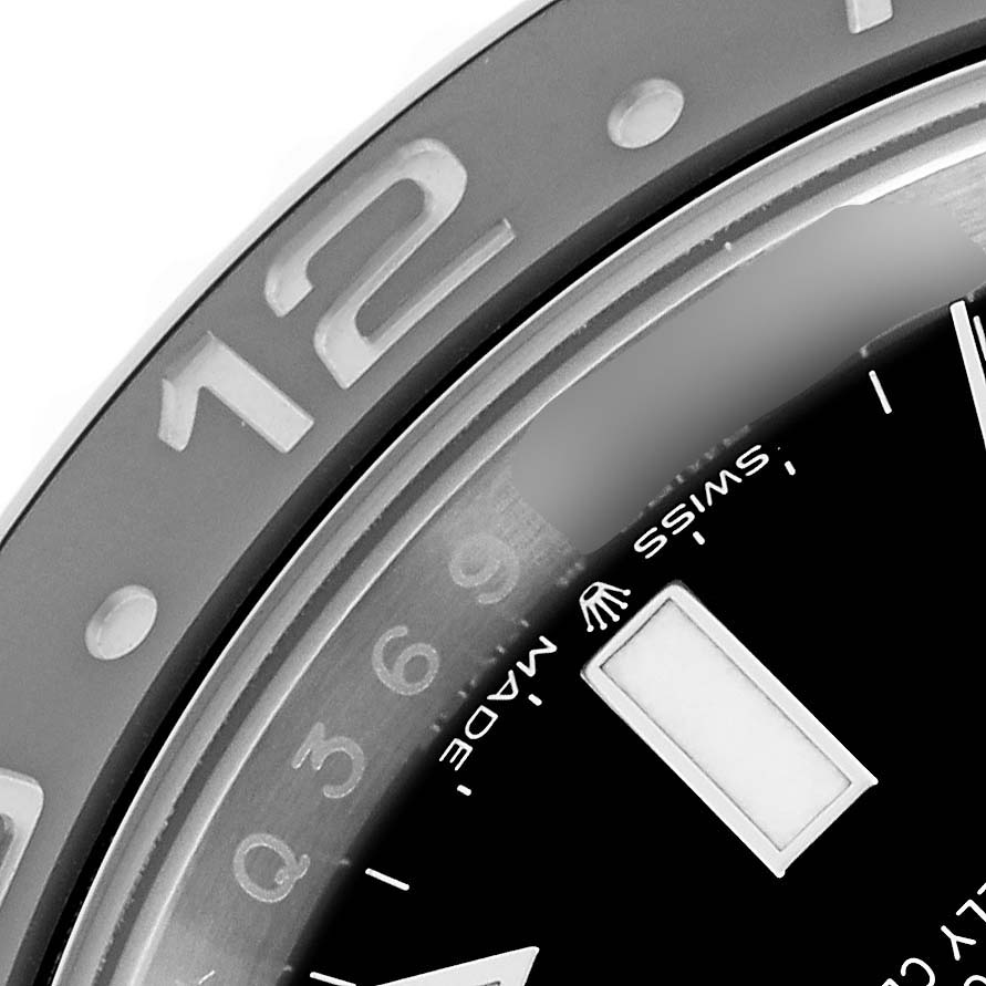 The image shows a close-up of the Rolex GMT-Master 126710GRNR Men's Stainless Steel Black Dial 126710GRNR Men's Stainless Steel Black Dial's bezel and part of the dial, featuring hour markers and branding.