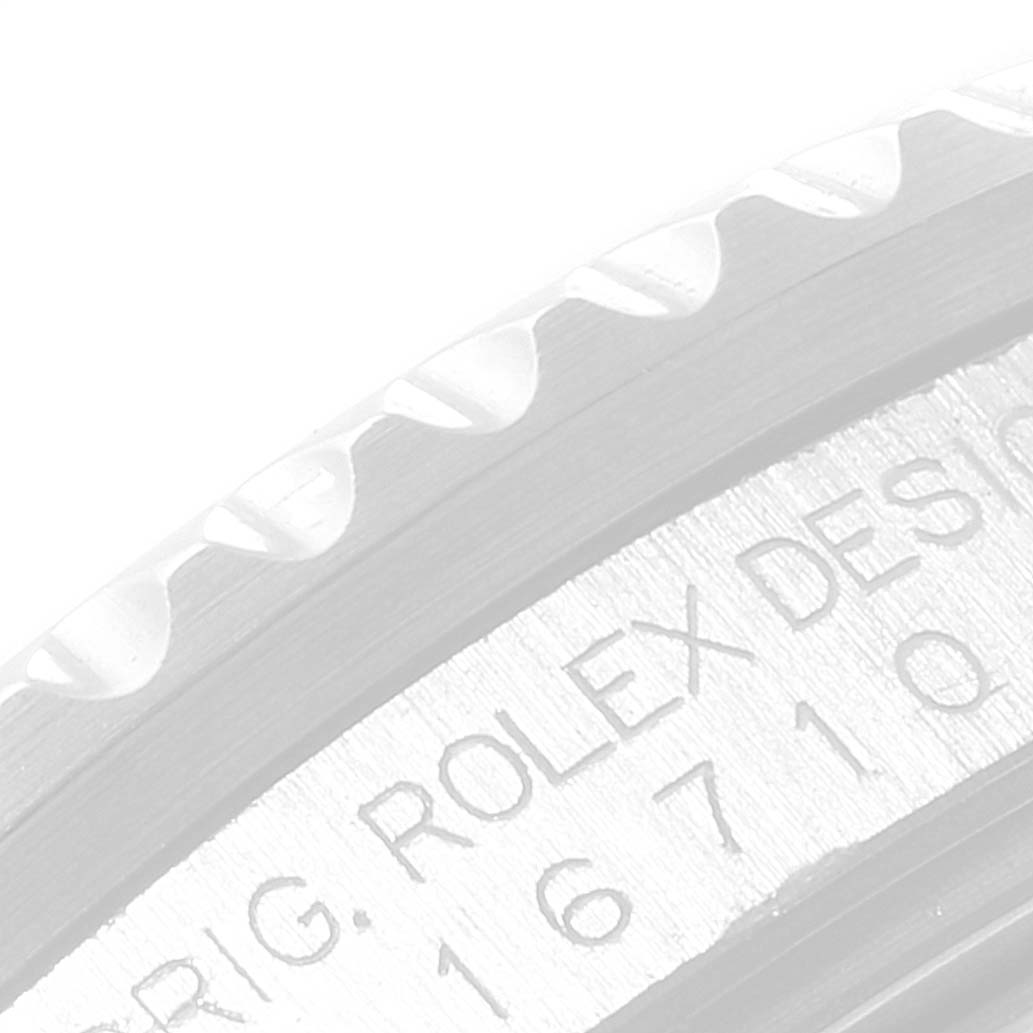 This image shows a partial, close-up angle of the bezel and engraved serial number of a Rolex GMT-Master 16710 Men
s Stainless Steel Black Dial 16710 Men
s Stainless Steel Black Dial watch.