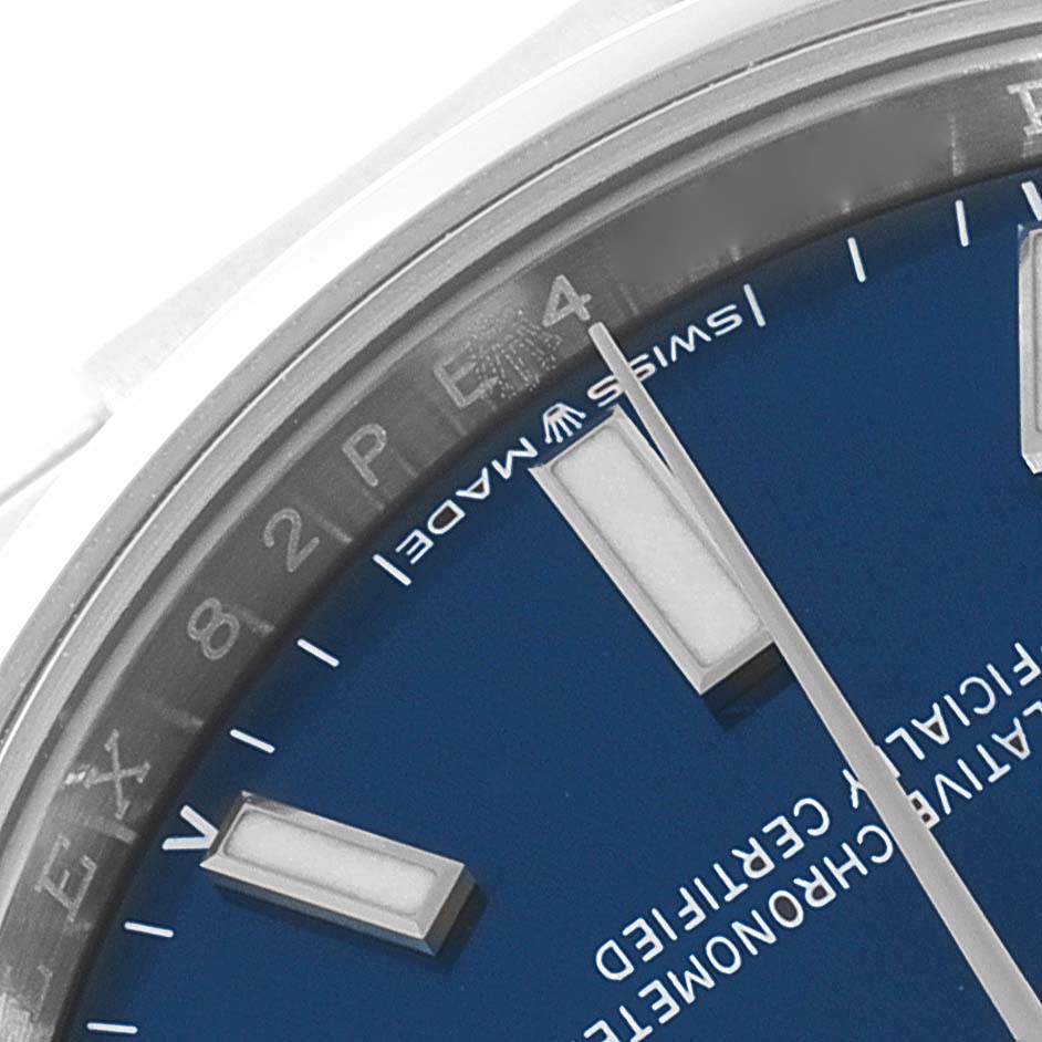 The image shows a close-up of the dial and edge of the bezel of a blue Rolex Oyster Perpetual 124200 Men's Stainless Steel Blue Dial 124200 Men's Stainless Steel Blue Dial watch, highlighting the hour markers and the text "Swiss Made."