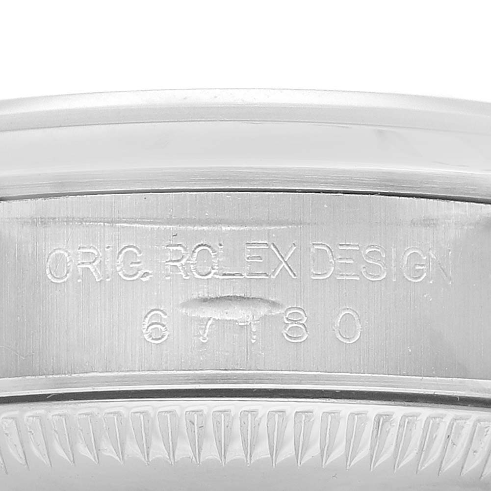 The image shows a close-up of the side engraving on a Rolex Oyster Perpetual 67180 Women's Stainless Steel Black Dial watch case.