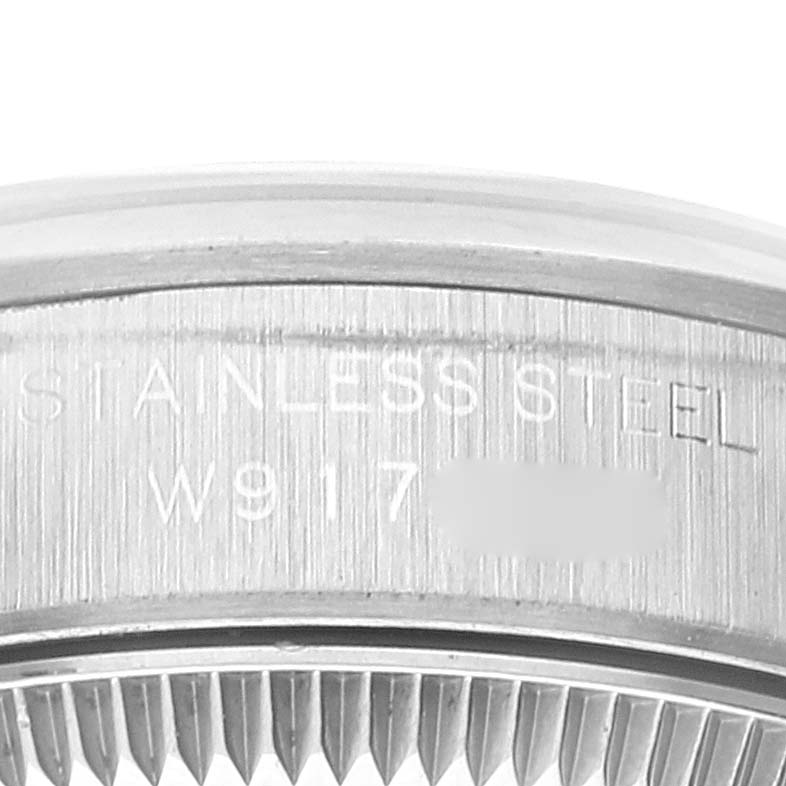 This close-up image shows the edge and markings on the stainless steel bezel of a Rolex Oyster Perpetual 67180 Women's Stainless Steel Blue Dial 67180 Women's Stainless Steel Blue Dial watch.