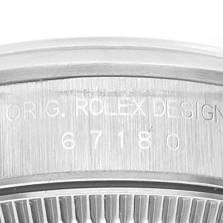 This image shows a close-up of the side of the case of a Rolex Oyster Perpetual 67180 Women's Stainless Steel Blue Dial 67180 Women's Stainless Steel Blue Dial, displaying the serial number and "ORIG. ROLEX DESIGN" engraving.