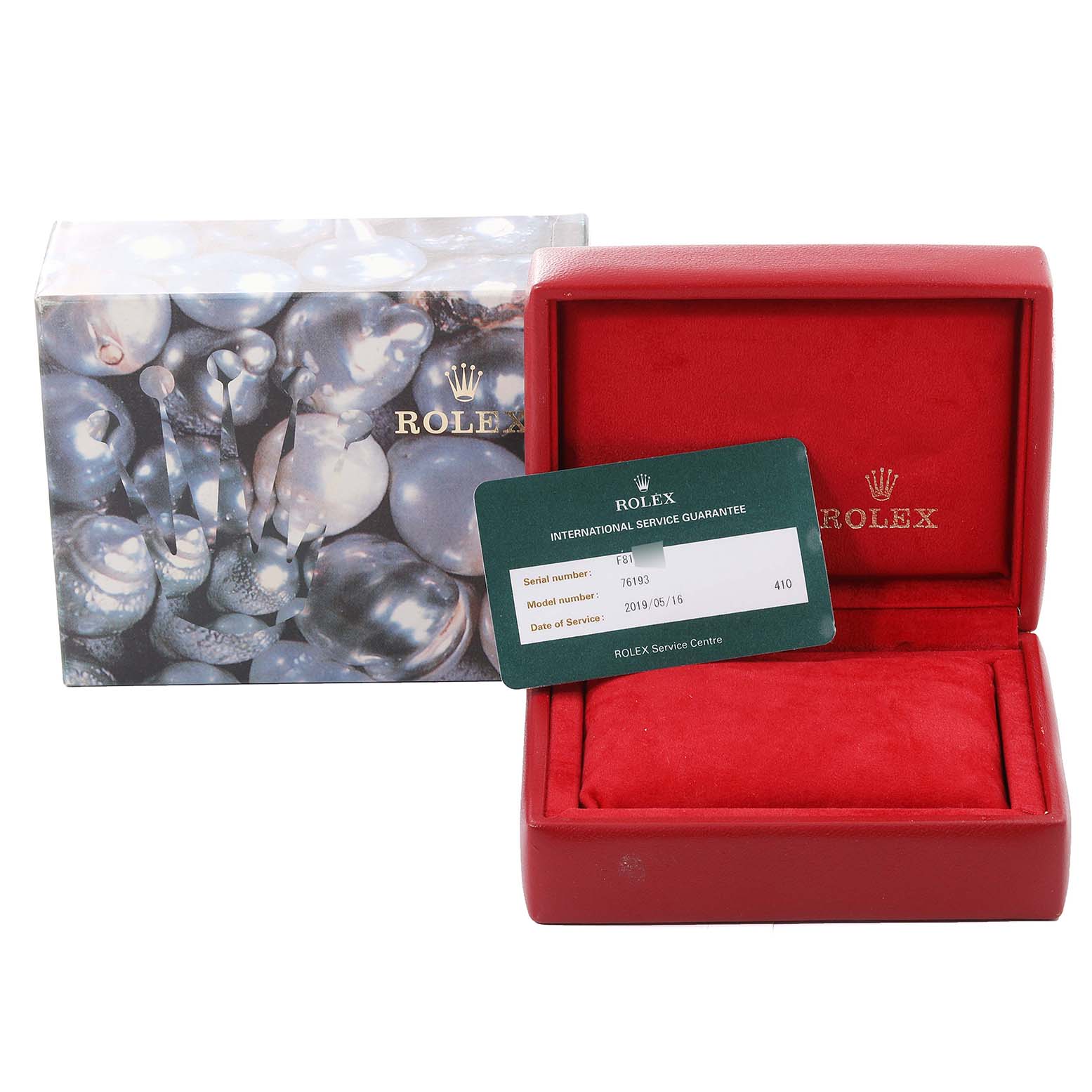 The image shows a Rolex Oyster Perpetual 76193 Women's Steel and Gold (two tone) Black Dial 76193 Women's Steel and Gold (two tone) Black Dial watch box, an outer box, and an international service guarantee card.