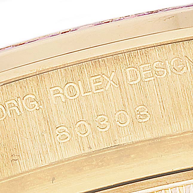 The image shows an engraved part of the Rolex Pearlmaster 80308 Women's Yellow Gold Mother of Pearl Dial 80308 Women's Yellow Gold Mother of Pearl Dial watch's case, viewed up-close from the side.