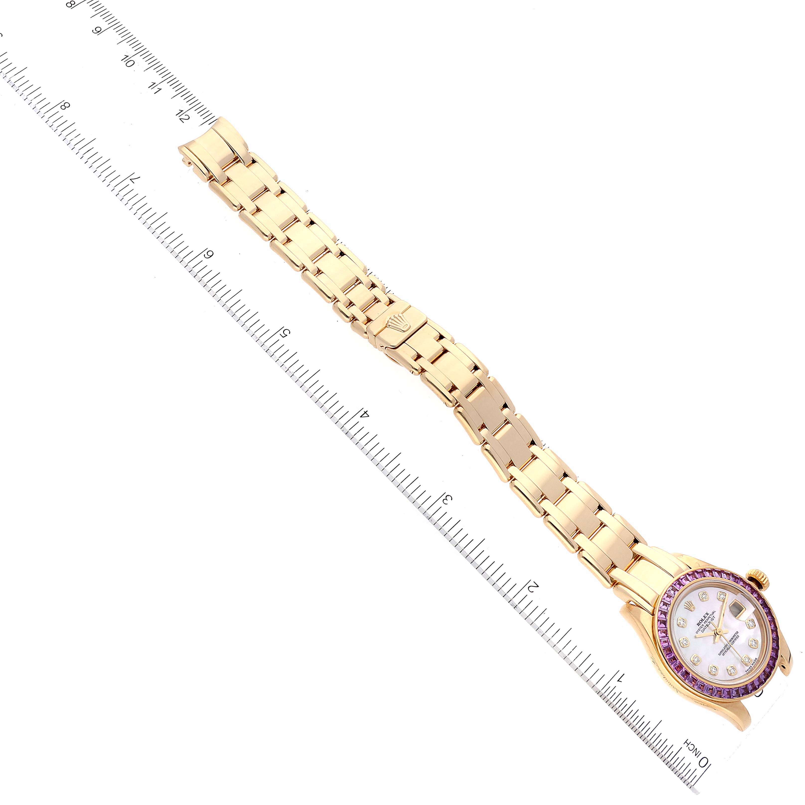 The image shows the Rolex Pearlmaster 80308 Women's Yellow Gold Mother of Pearl Dial 80308 Women's Yellow Gold Mother of Pearl Dial watch lying flat, with the watch face, bezel, and bracelet visible and aligned with a ruler.