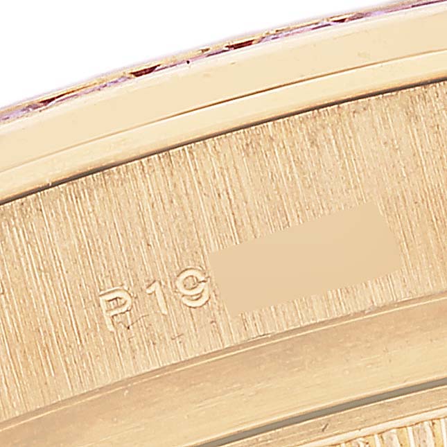 This close-up image shows the edge of a Rolex Pearlmaster 80308 Women's Yellow Gold Mother of Pearl Dial 80308 Women's Yellow Gold Mother of Pearl Dial watch, highlighting its engraving and part of the bezel.