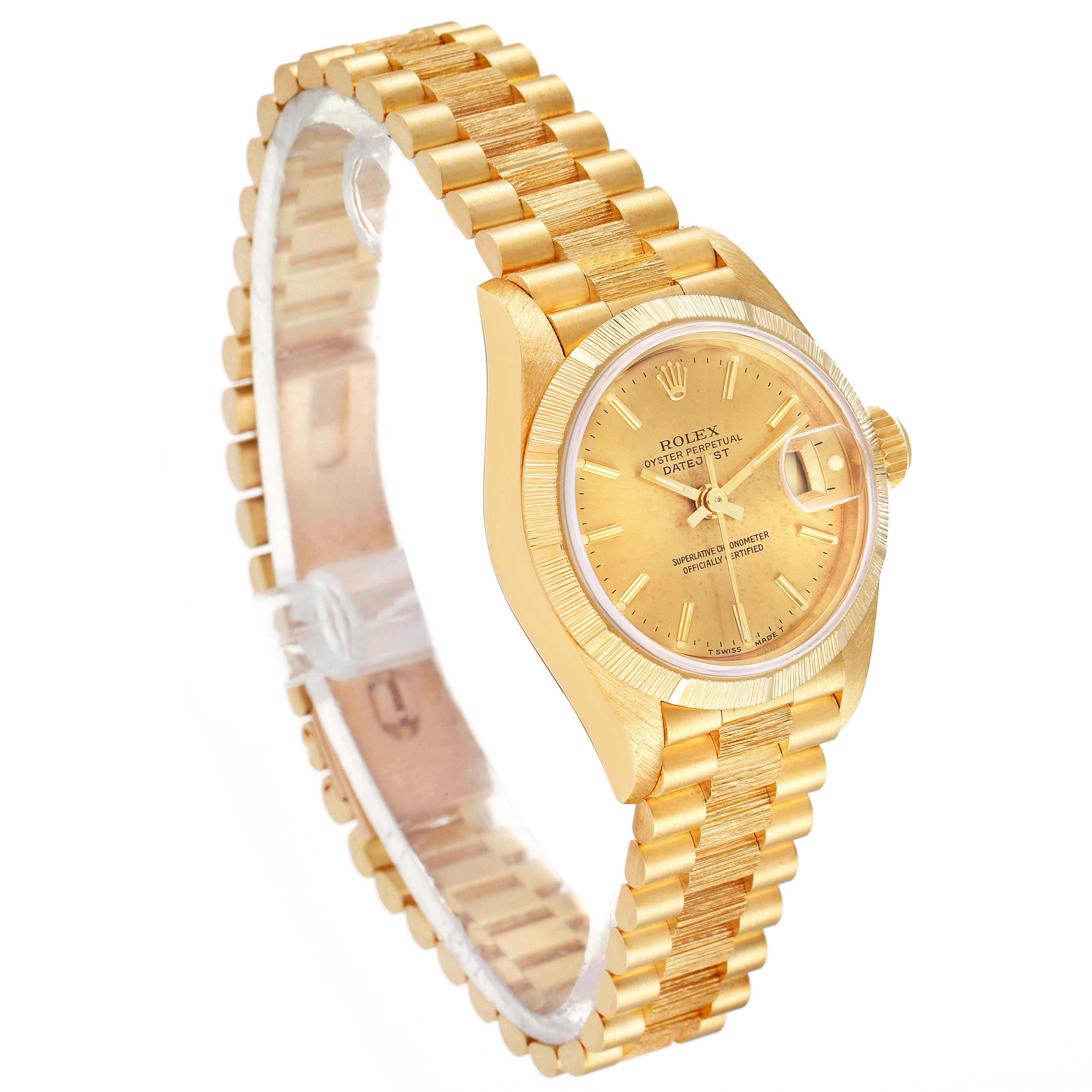 The image shows a side angle of a Rolex President 69278 Women's Yellow Gold Champagne Dial 69278 Women's Yellow Gold Champagne Dial model watch, highlighting its gold bracelet and round dial with a date window.