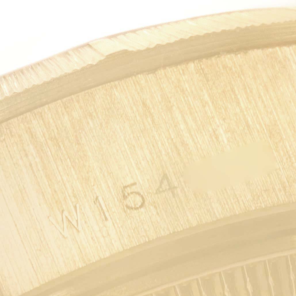 This image shows a close-up of the side of a Rolex President 69278 Women's Yellow Gold Champagne Dial 69278 Women's Yellow Gold Champagne Dial model, focusing on the engraved serial number.