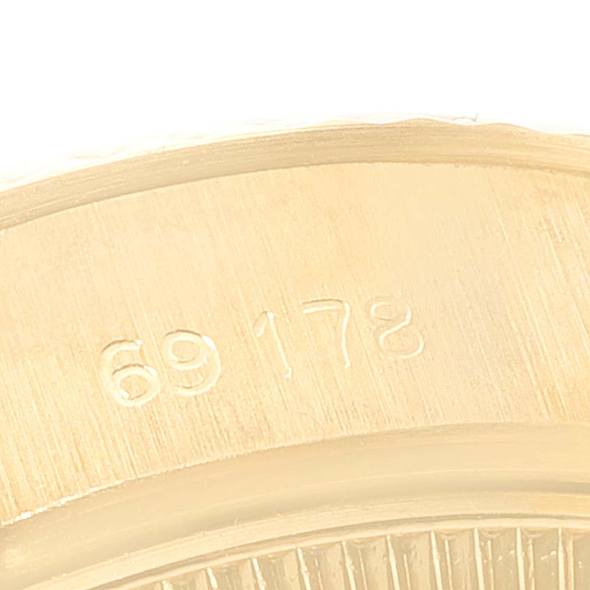 This close-up image shows part of the case back with serial number 69178 of the Rolex President 69178 Women
s Yellow Gold Champagne Dial 69178 Women
s Yellow Gold Champagne Dial model watch.