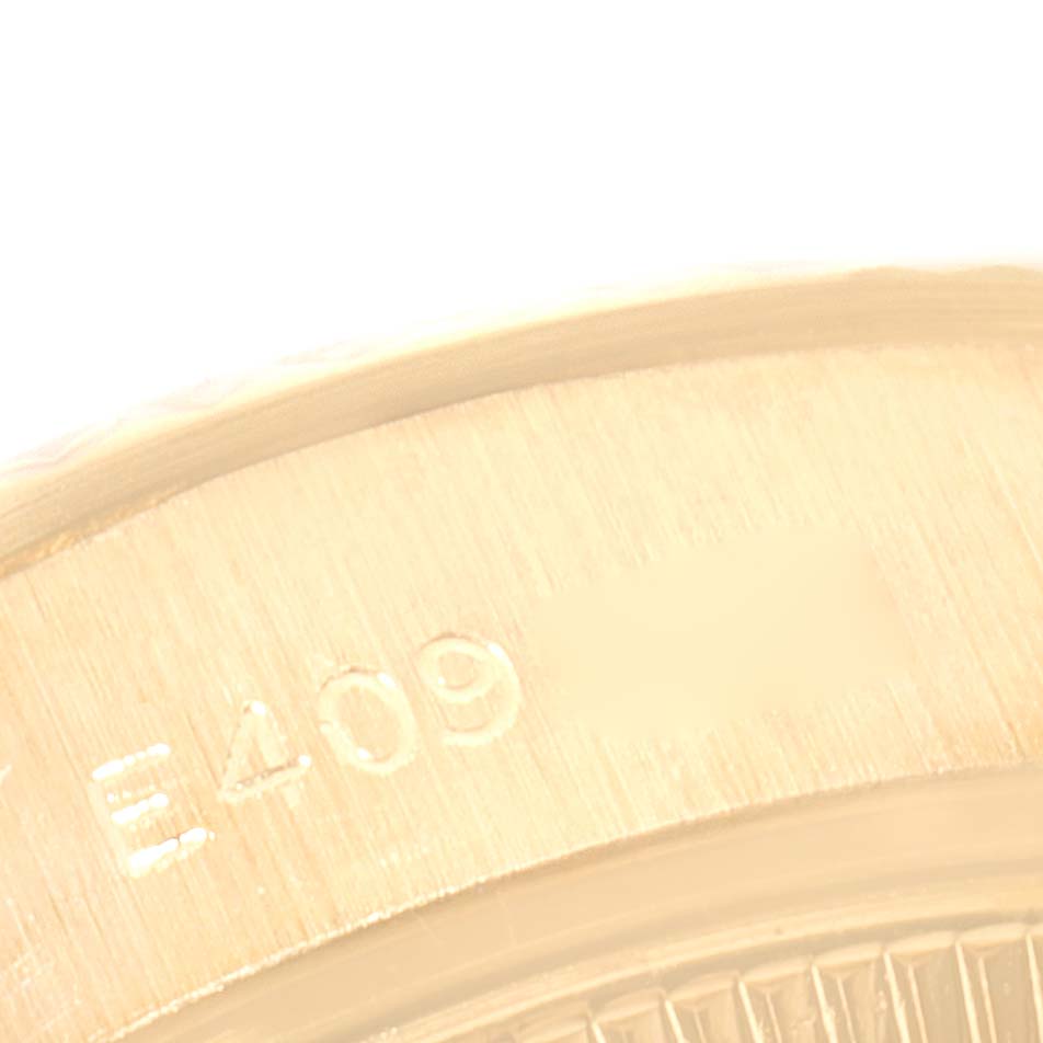 The image shows a close-up angle of the engraved serial number on the side of a Rolex President 69178 Women
s Yellow Gold Champagne Dial 69178 Women
s Yellow Gold Champagne Dial model watch.
