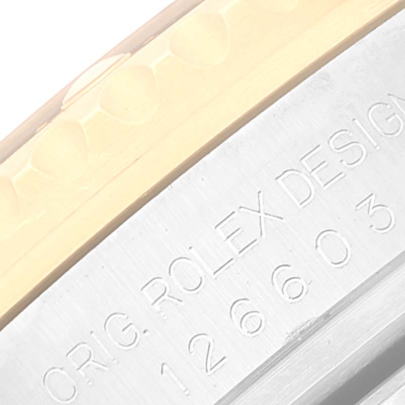 The image shows a close-up of the edge of the bezel and the engraved side of the case on the Rolex Sea-Dweller 126603 Men
s Steel and Gold (two tone) Black Dial 126603 Men
s Steel and Gold (two tone) Black Dial watch.