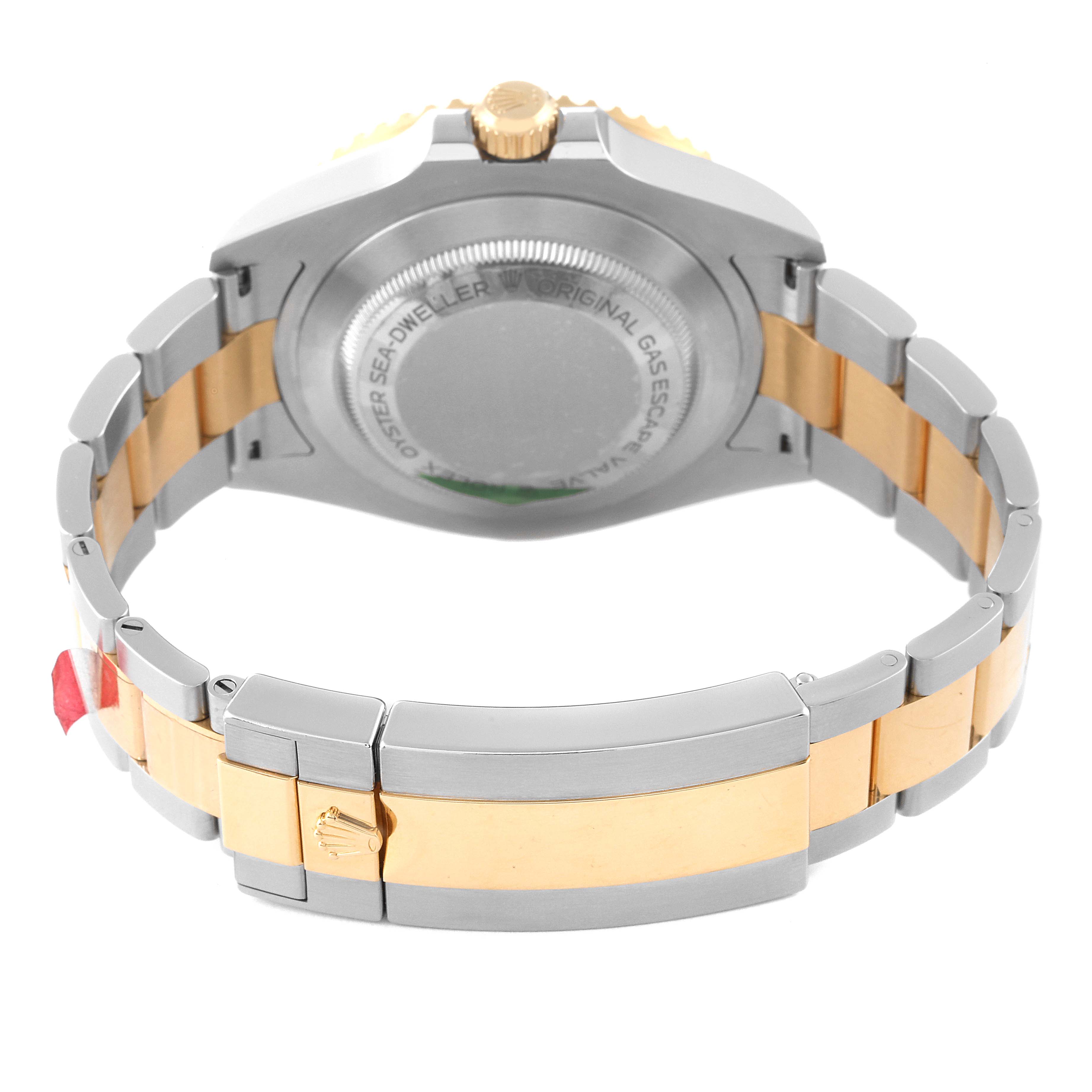 The image shows the back and bracelet of a Rolex Sea-Dweller 126603 Men
s Steel and Gold (two tone) Black Dial 126603 Men
s Steel and Gold (two tone) Black Dial watch, featuring silver and gold tones.