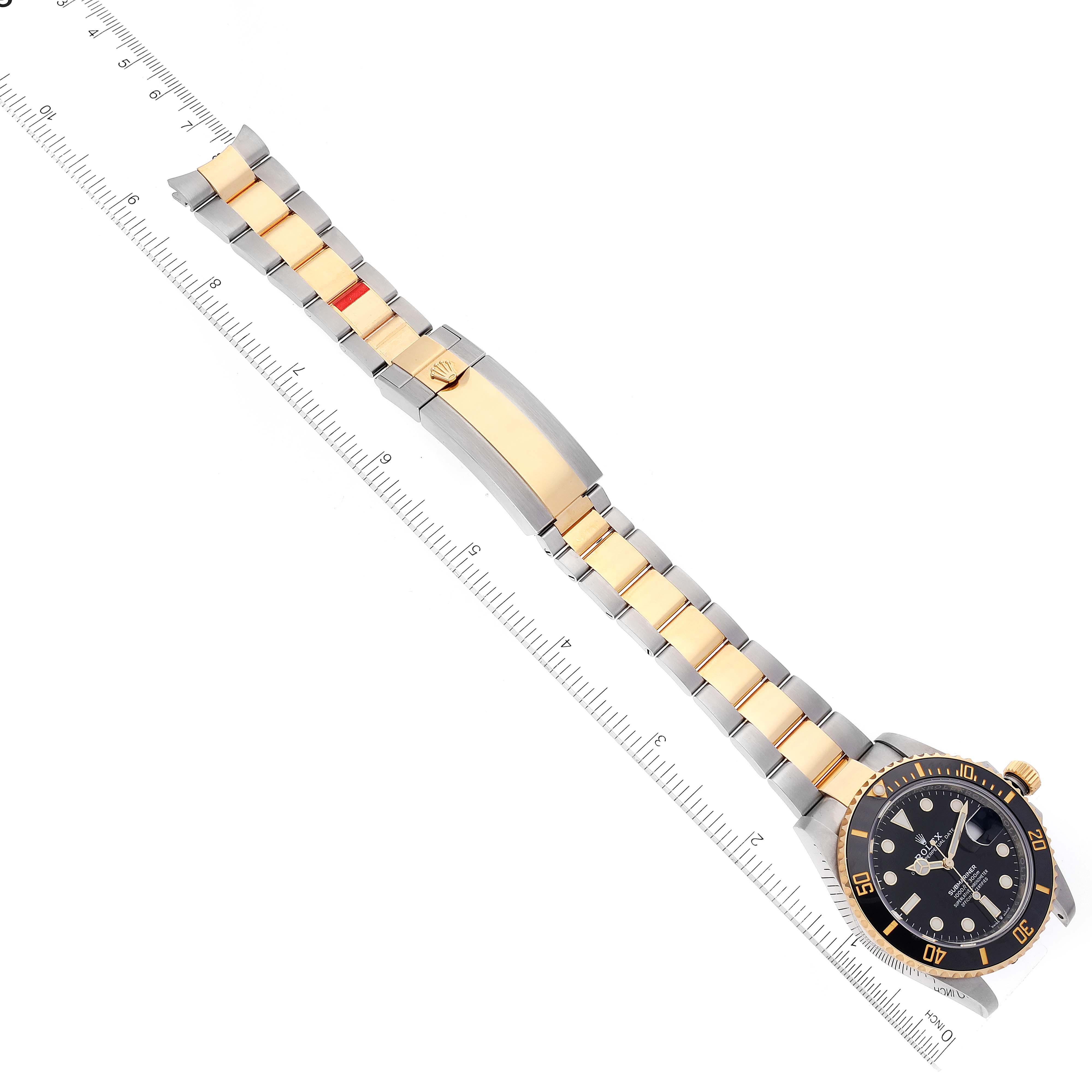 The image shows a top view of a Rolex Submariner 126613 Men's Steel and Gold (two tone) Black Dial 126613 Men's Steel and Gold (two tone) Black Dial watch and its bracelet, aligned with a measuring ruler.