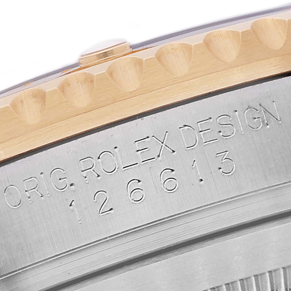The image shows a close-up of the side of the Rolex Submariner 126613 Men's Steel and Gold (two tone) Black Dial 126613 Men's Steel and Gold (two tone) Black Dial, highlighting the bezel and engraved model number.