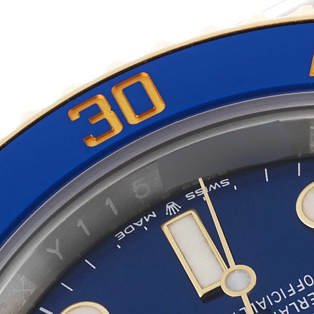 This image shows a close-up of the bezel and dial of a Rolex Submariner 126613 Men's Steel and Gold (two tone) Blue Dial 126613 Men's Steel and Gold (two tone) Blue Dial watch, highlighting the 30-minute marker and part of the face.