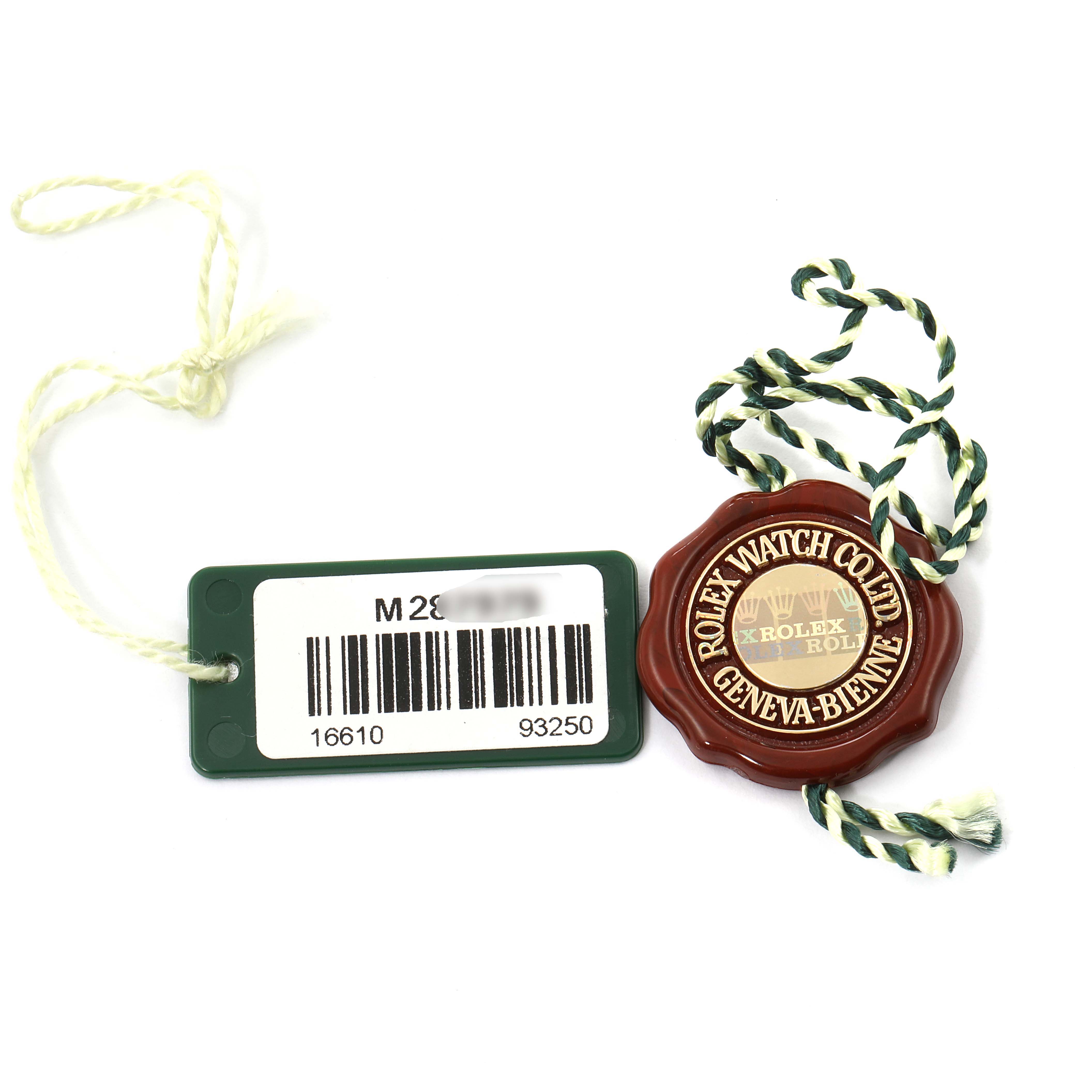 The image shows a Rolex Submariner 16610 Men's Stainless Steel Black Dial 16610 Men's Stainless Steel Black Dial hang tag and seal with the brand's logo and a barcode tag.