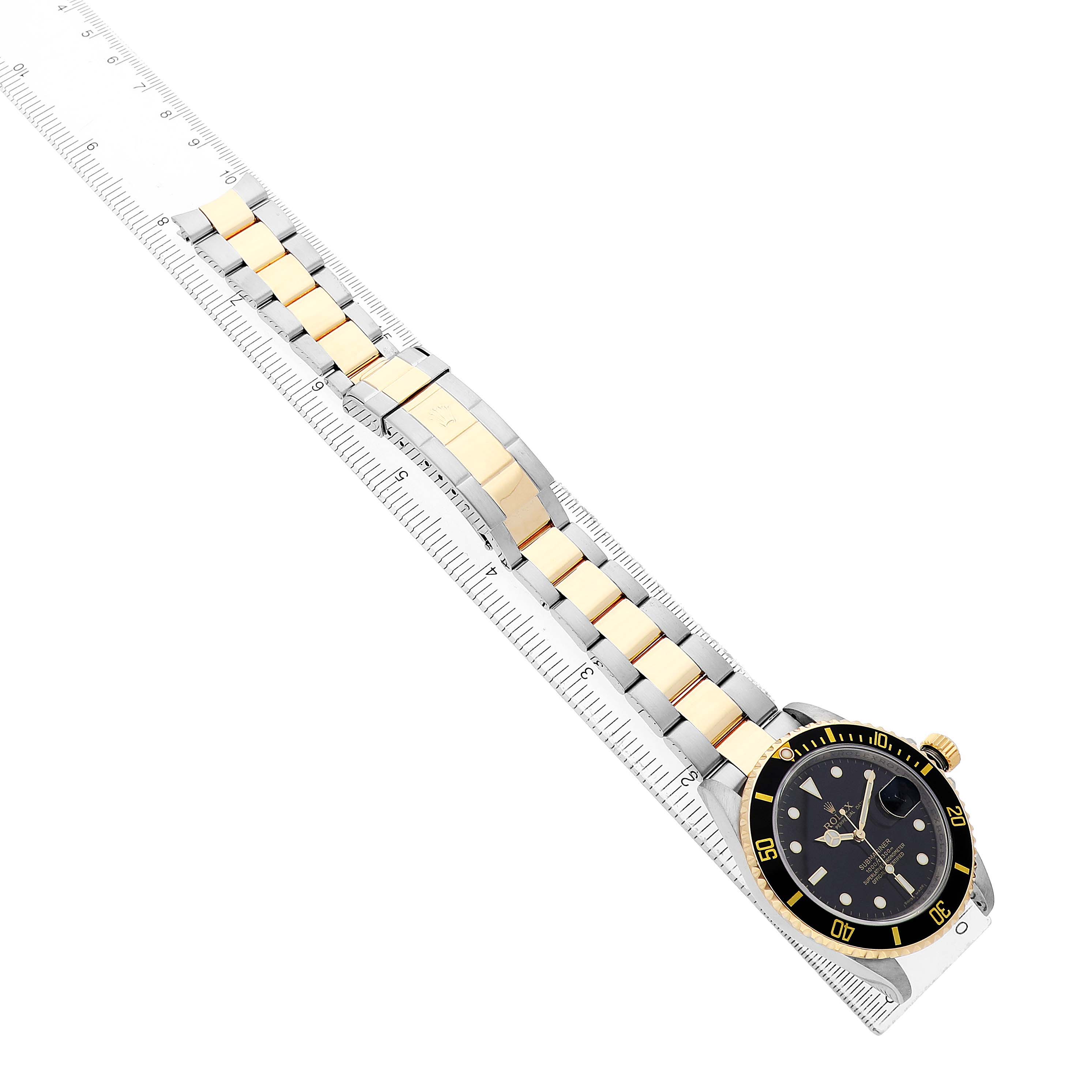 The Rolex Submariner 16613 Men's Steel and Gold (two tone) Black Dial watch is shown at a side angle, highlighting the bracelet, clasp, and face.