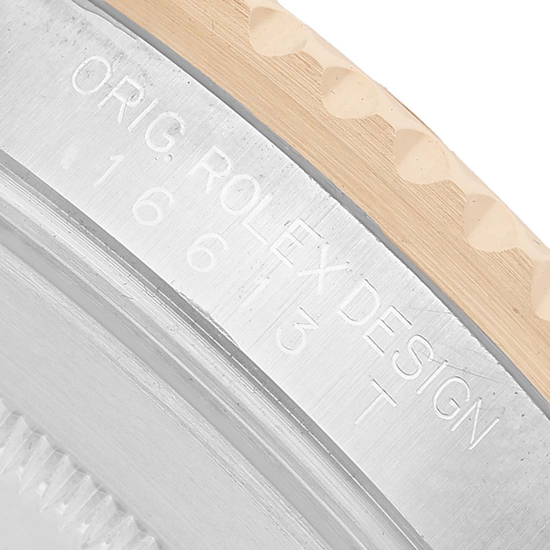 The image shows a close-up of the side of a Rolex Submariner 16613 Men's Steel and Gold (two tone) Black Dial, highlighting the engraved model number and part of the bezel.