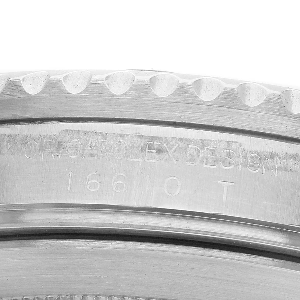 The image shows a close-up of the engraving on the side of the Rolex Submariner 16610 Men's Stainless Steel Black Dial's case, highlighting its model number "16610".