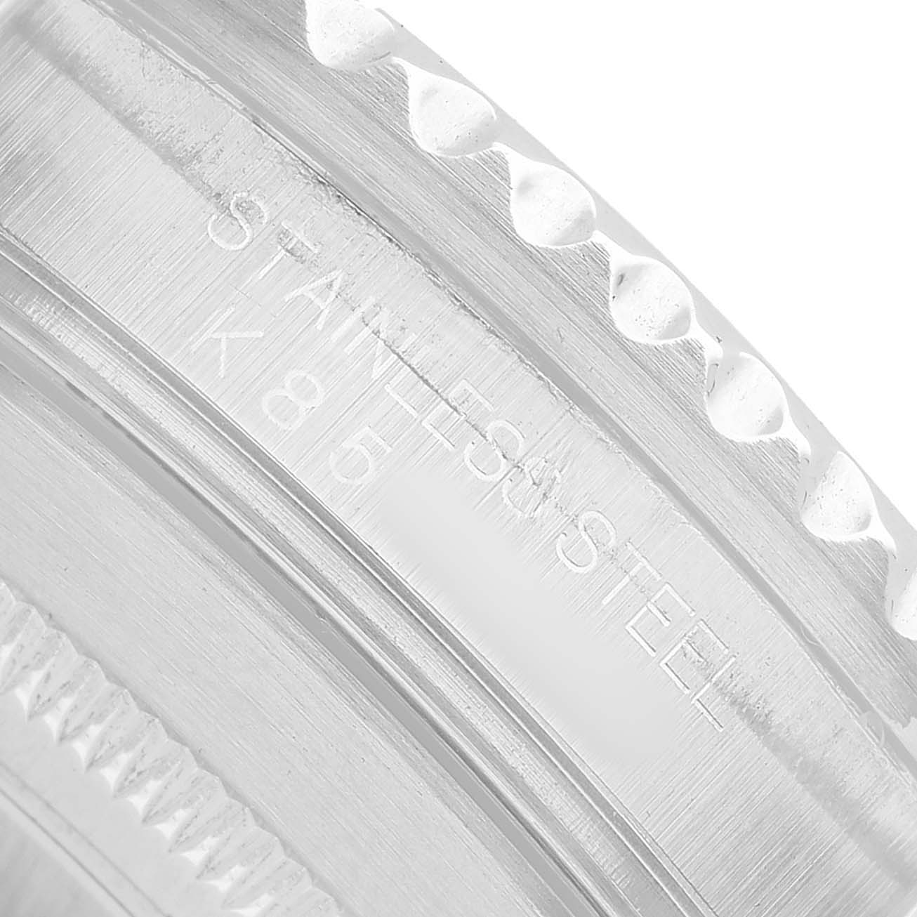 The image shows a close-up of the stainless steel bezel of a Rolex Submariner 16610 Men's Stainless Steel Black Dial.