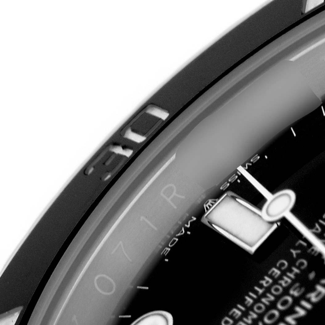 The image shows a close-up of the bezel and partial dial of a Rolex Submariner 124060 Men's Stainless Steel Black Dial, highlighting the 30-minute mark and hour hand.