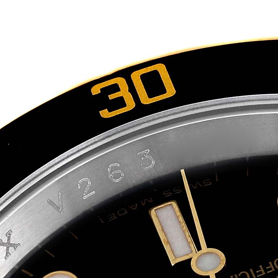 This close-up image of a Rolex Submariner 16613 Men's Steel and Gold (two tone) Black Dial 16613 Men's Steel and Gold (two tone) Black Dial watch shows the bezel with a "30" marking and part of the dial with indices.