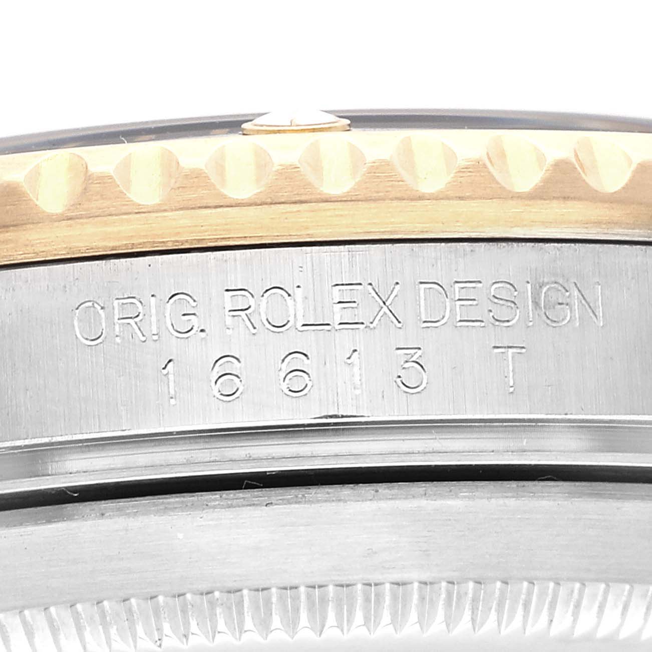 The image shows a close-up of the side of the bezel and case of a Rolex Submariner 16613 Men's Steel and Gold (two tone) Black Dial 16613 Men's Steel and Gold (two tone) Black Dial, highlighting the model number 16613T engraved on it.
