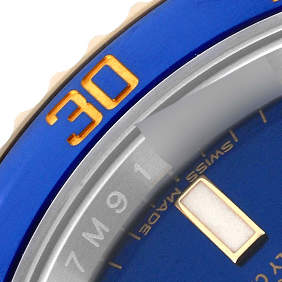 This close-up image shows the bezel with the "30" marker and part of the dial of a Rolex Submariner 116613 Men's Steel and Gold (two tone) Blue Dial 116613 Men's Steel and Gold (two tone) Blue Dial watch.