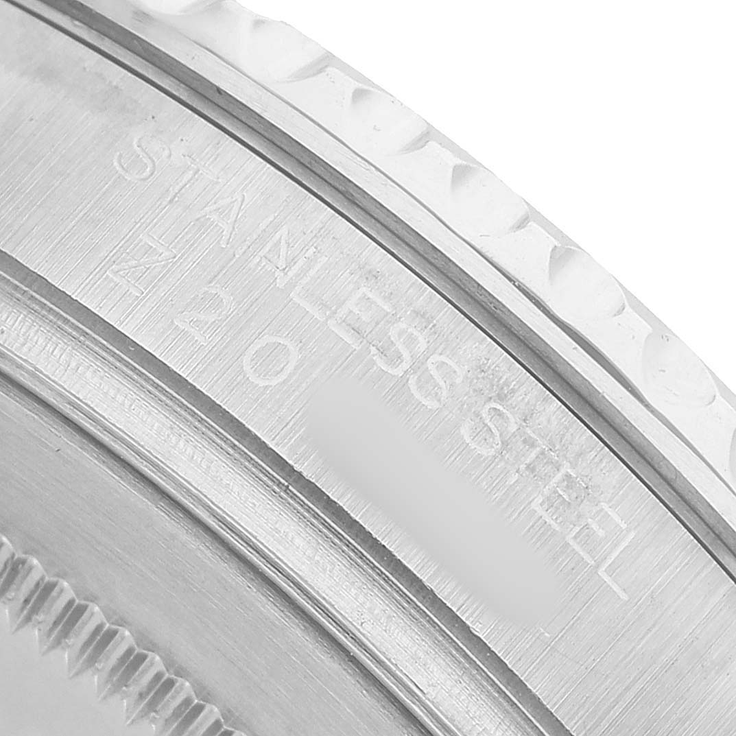 The image shows a close-up of the side of a Rolex Yacht-Master 16622 Men's Stainless Steel Silver Dial watch, highlighting the stainless steel case with engraved text.