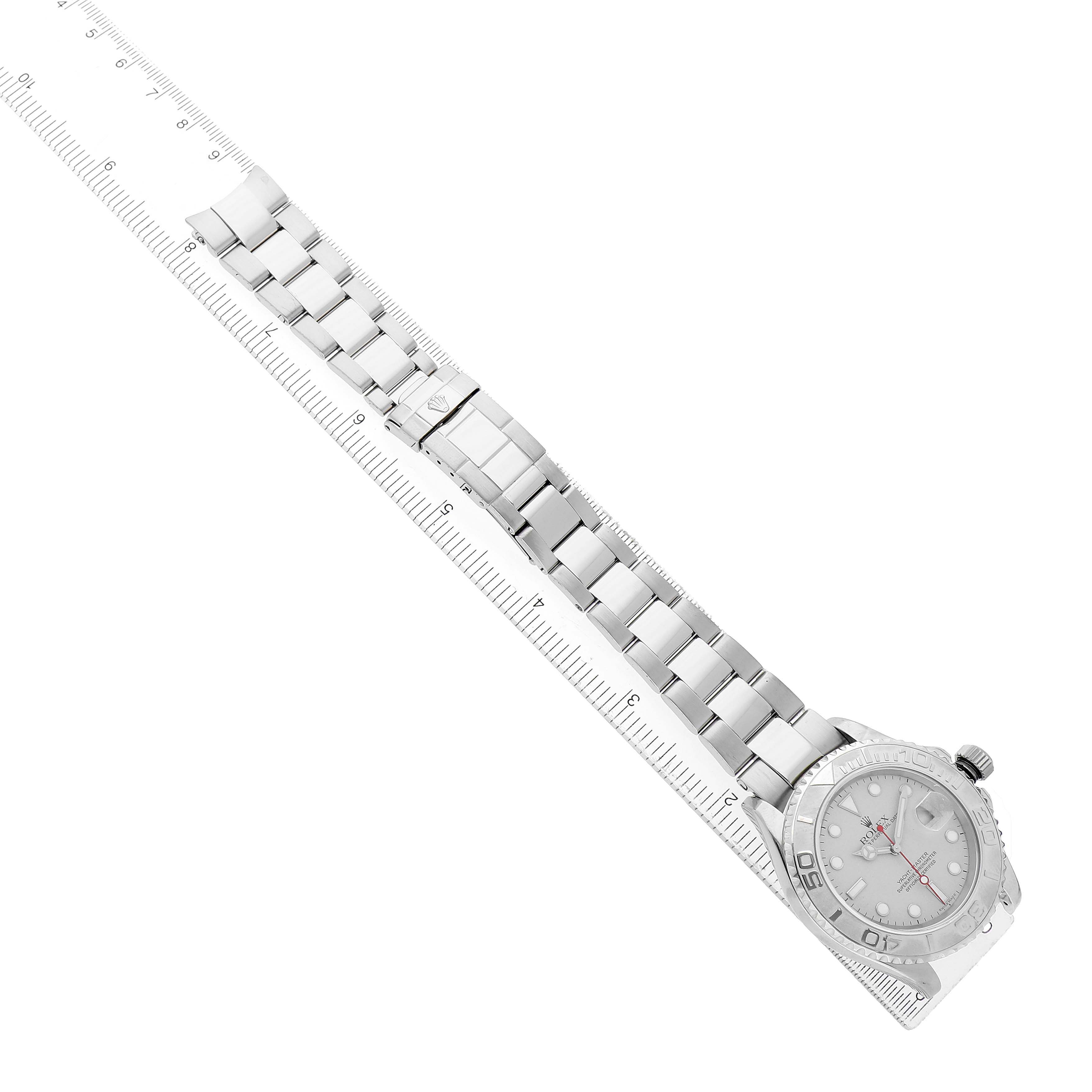 The image shows a top-down view of a Rolex Yacht-Master 16622 Men's Stainless Steel Silver Dial watch and its metal bracelet.