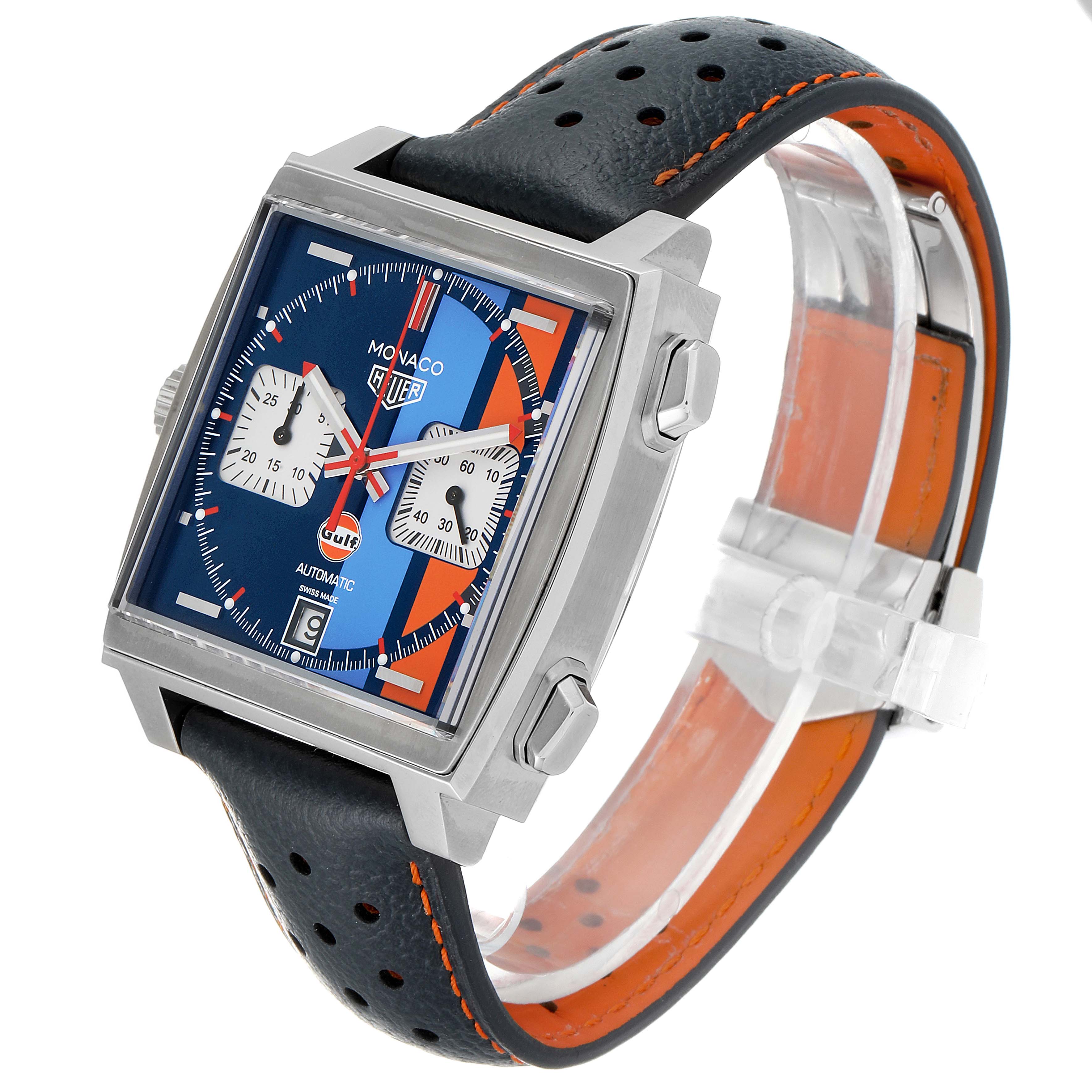 The image shows a Tag Heuer Monaco CAW211R.FC6401 Men's Stainless Steel Blue Dial CAW211R.FC6401 Men's Stainless Steel Blue Dial watch angled to display the face, crown, and perforated leather strap.