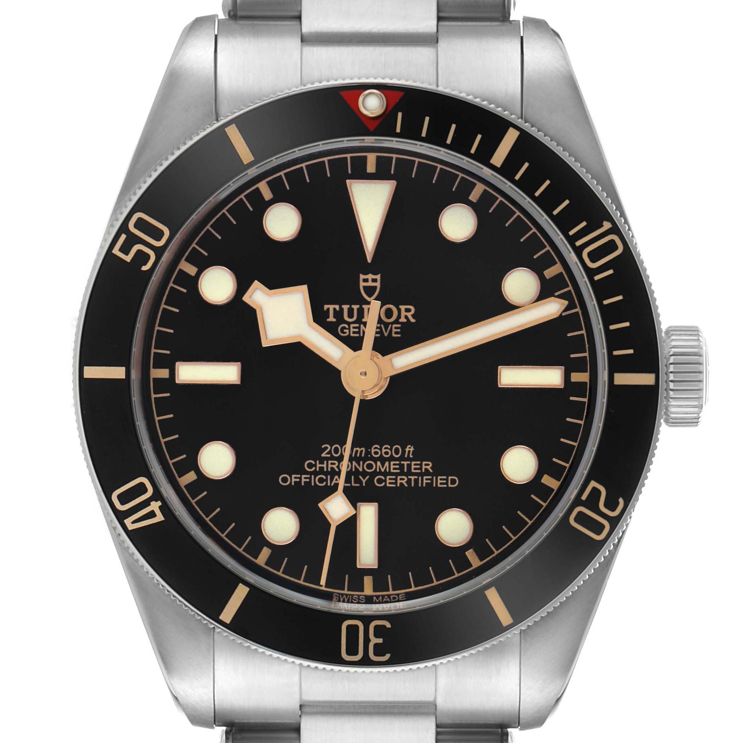 The Tudor Heritage Black Bay 79030 Men's Stainless Steel Black Dial watch is shown from the front, highlighting the dial, bezel, crown, and part of the bracelet.