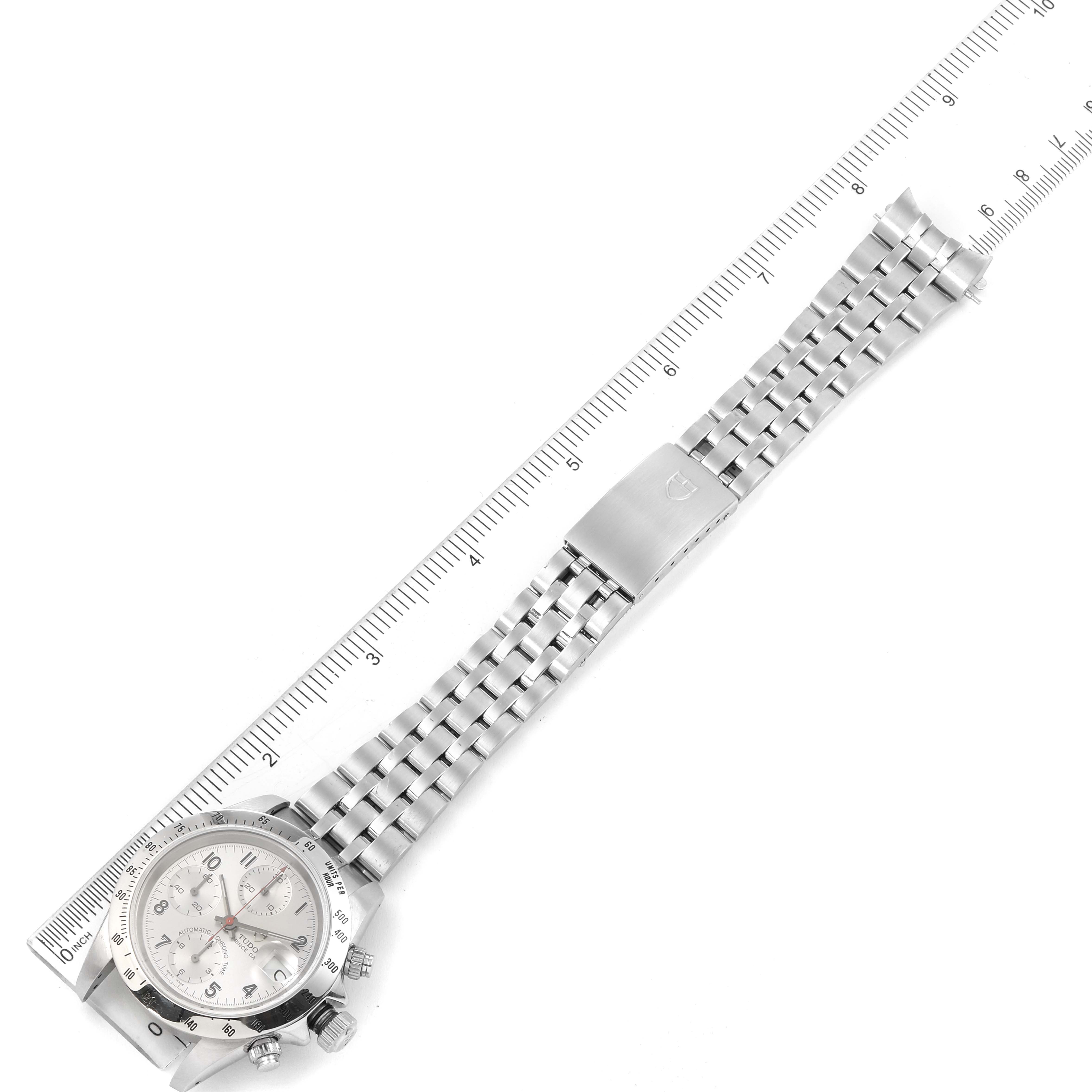 The image shows a Tudor Tiger 79280 Men's Stainless Steel Silver Dial 79280 Men's Stainless Steel Silver Dial model watch laid flat, highlighting the face, bezel, and bracelet alongside a ruler for scale. 