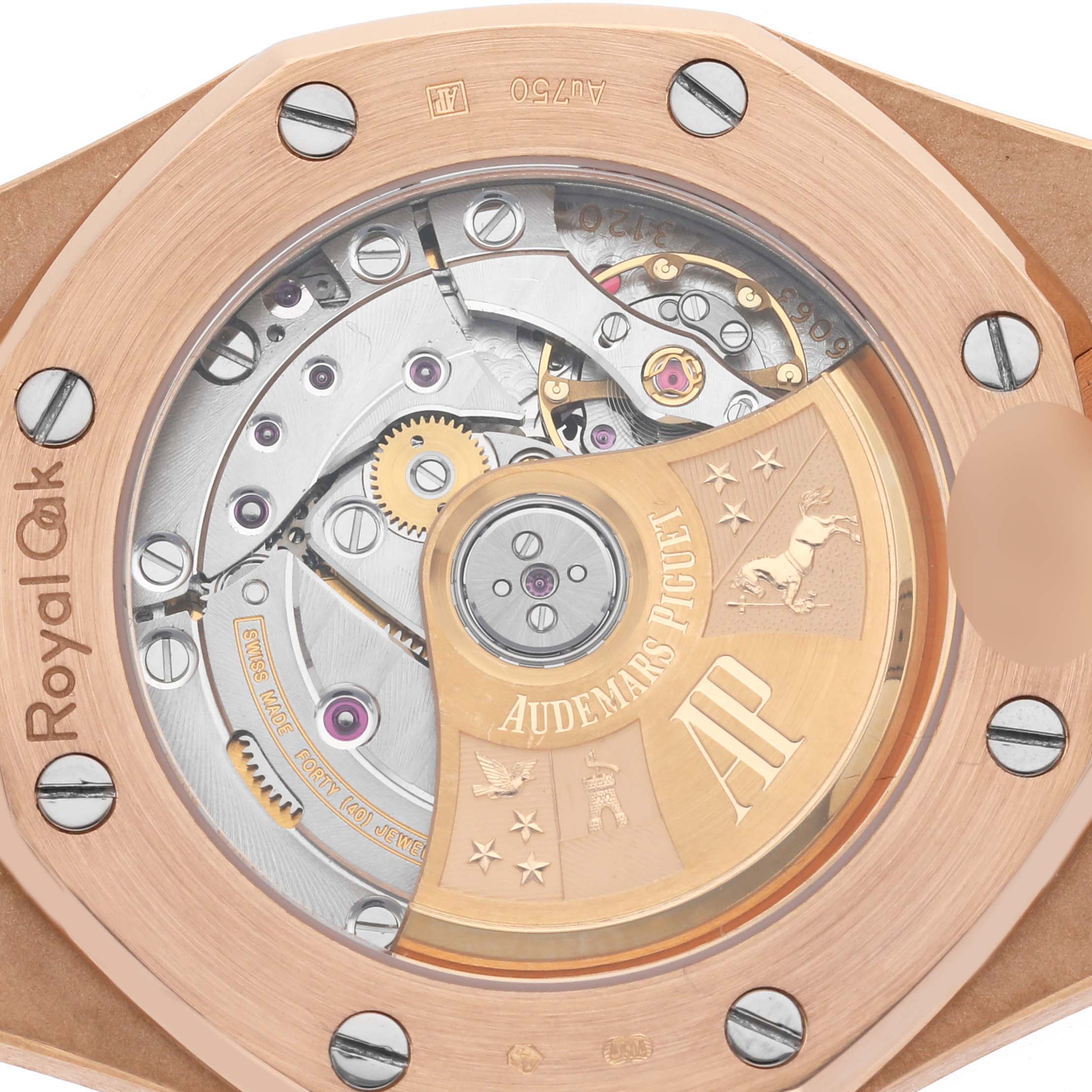 The image shows the open case back of a Royal Oak by Audemars Piguet, highlighting the movement and rotor.