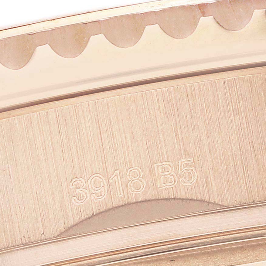 This close-up of the Breitling Aviator RB0117131Q1P1 Men's Rose Gold Brown Dial shows part of the engraved case with a portion of the notched edge.