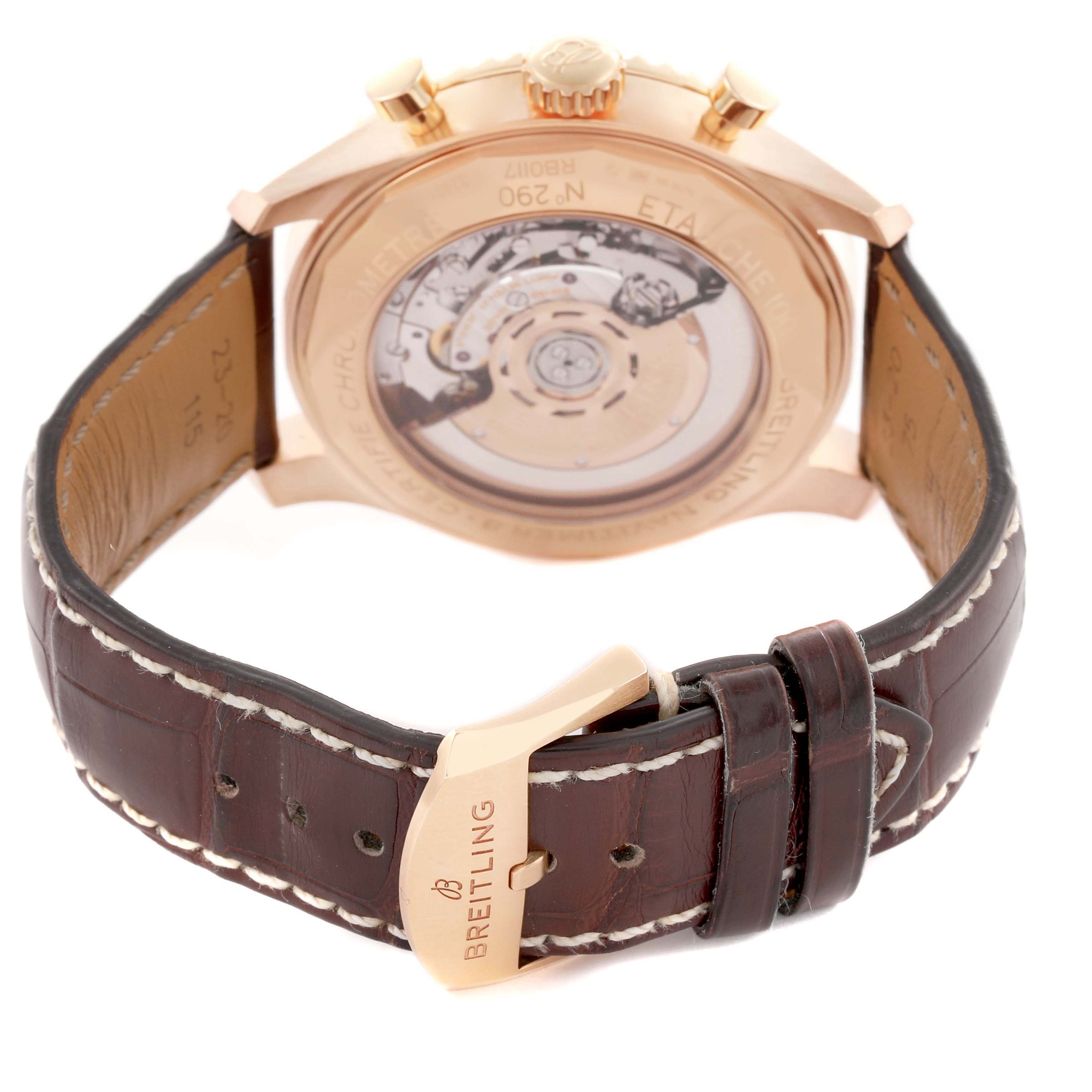 The image shows the back view of a Breitling Aviator RB0117131Q1P1 Men's Rose Gold Brown Dial watch, displaying the transparent case back and leather strap with a clasp.