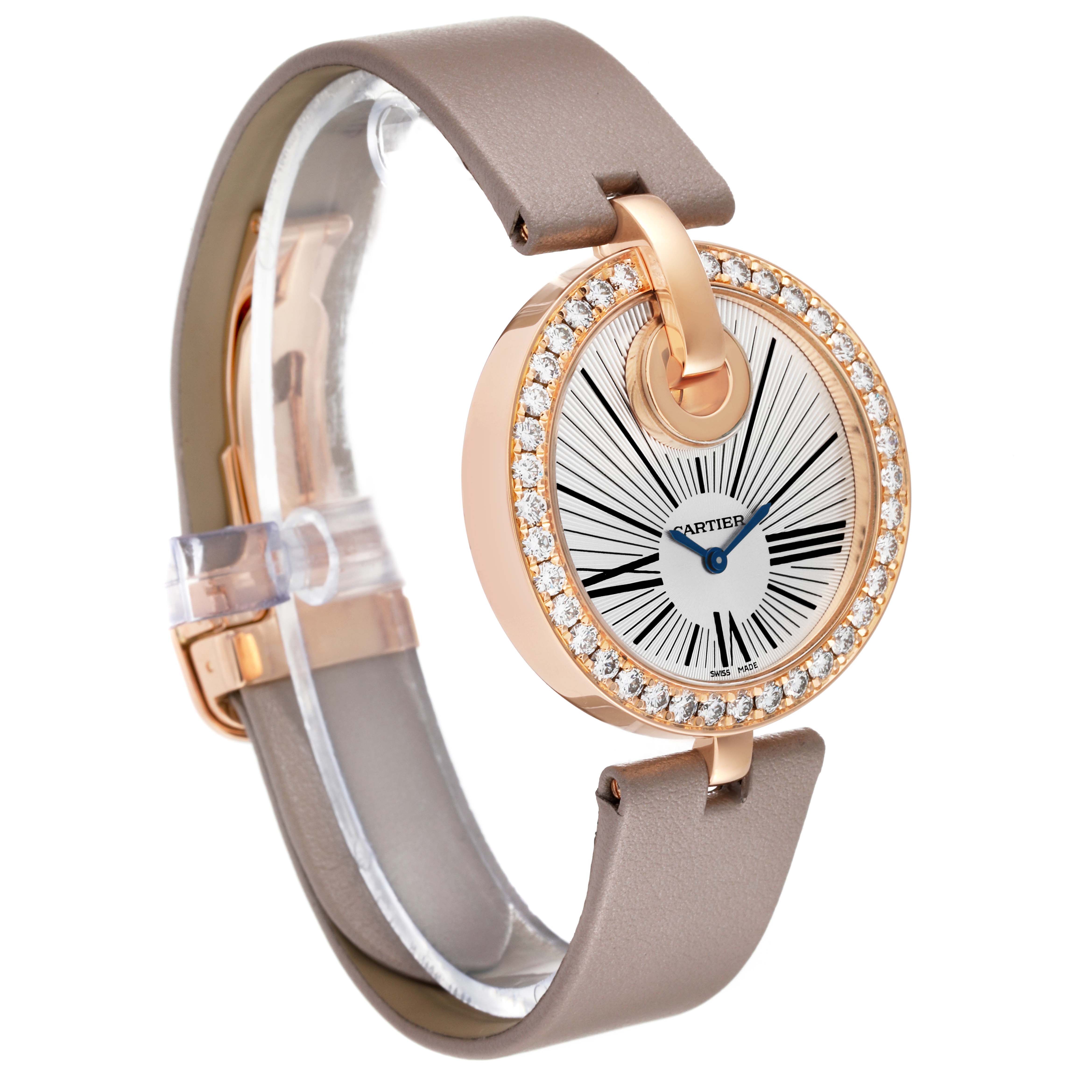 This image shows a Cartier Ballon Bleu WG600011 Women's Rose Gold Silver Dial WG600011 Women's Rose Gold Silver Dial watch at a diagonal angle, highlighting its round face, crystal-studded bezel, and leather strap.