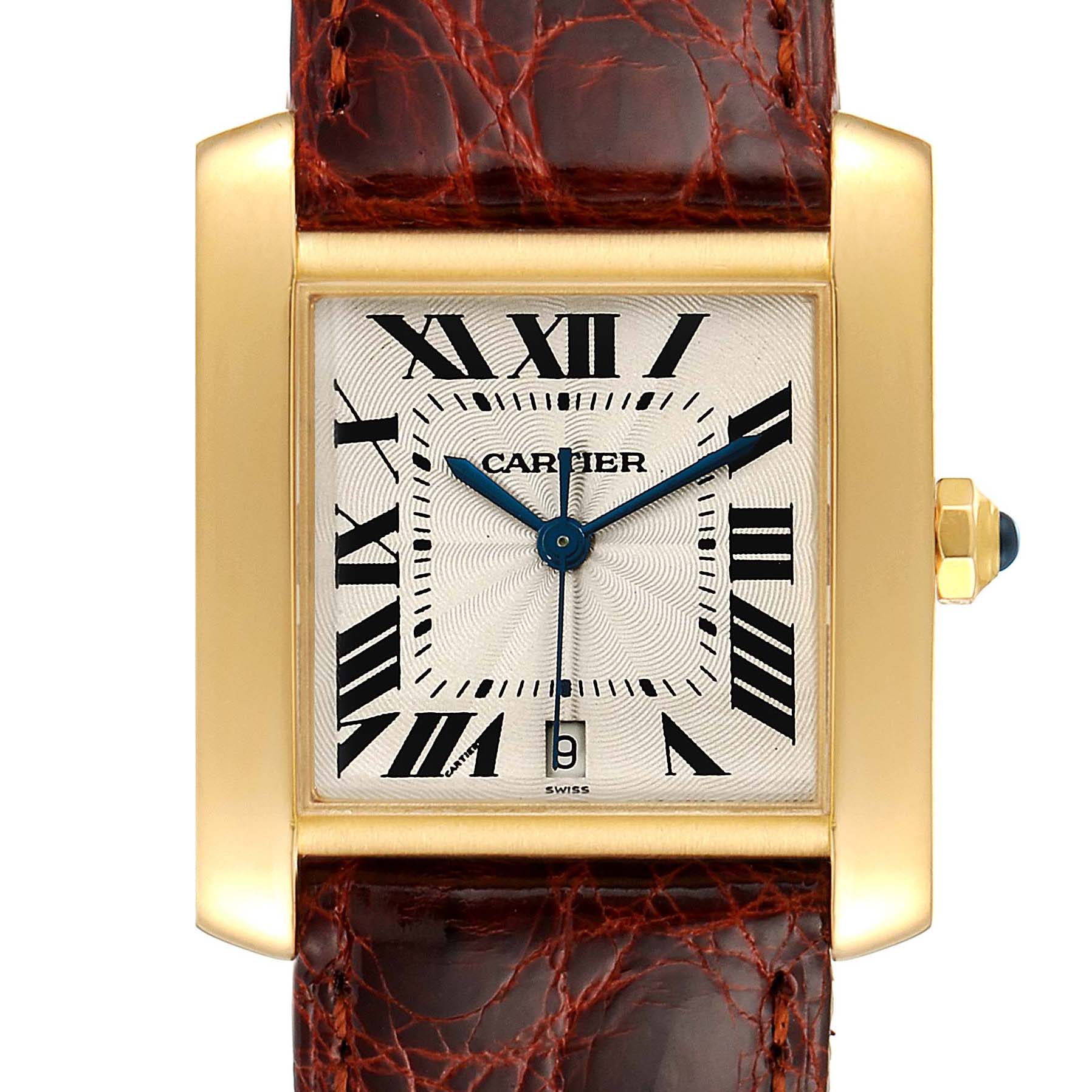 This image shows a front view of a Cartier Tank Francaise W5000156 Men's Yellow Gold Silver Dial W5000156 Men's Yellow Gold Silver Dial watch, displaying its dial, Roman numerals, blue hands, date window, and gold casing with a brown leather strap.