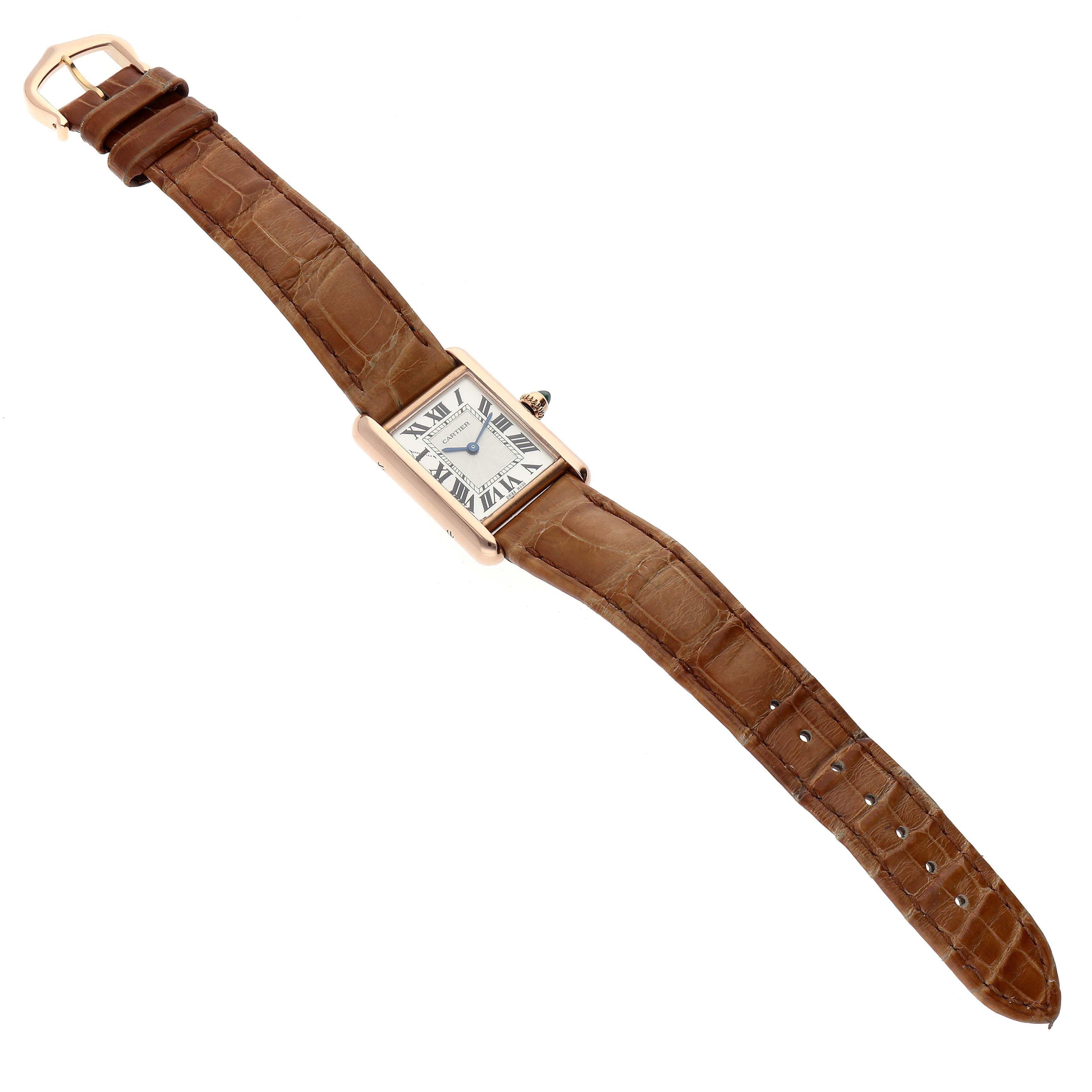 The image shows a Tank Louis model by Cartier from a top-down angle, featuring the entire watch and leather strap.
