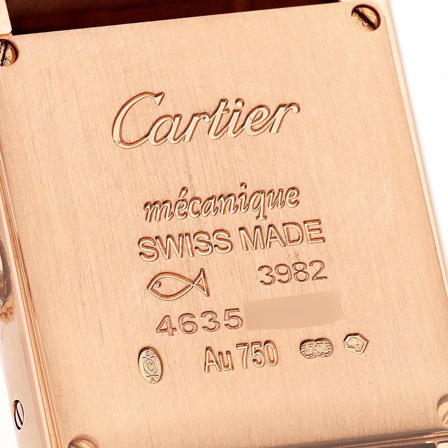 The image shows the engraved back case of a Tank Louis model by Cartier, displaying its serial number and details.