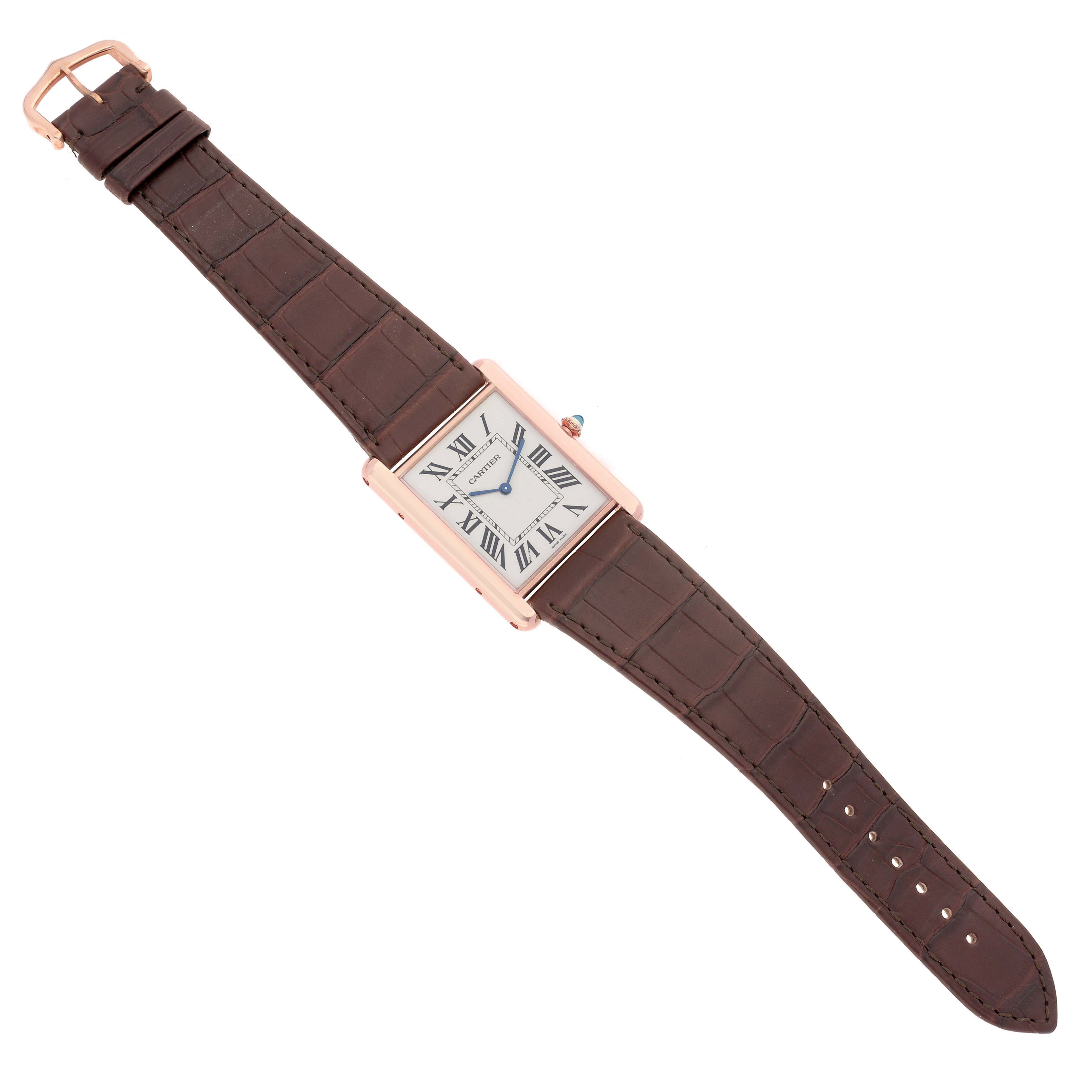 The Cartier Tank Louis W1560017 Men's Rose Gold Silver Dial W1560017 Men's Rose Gold Silver Dial watch is shown from a top-down angle, displaying the face, Roman numerals, hands, and brown leather strap.