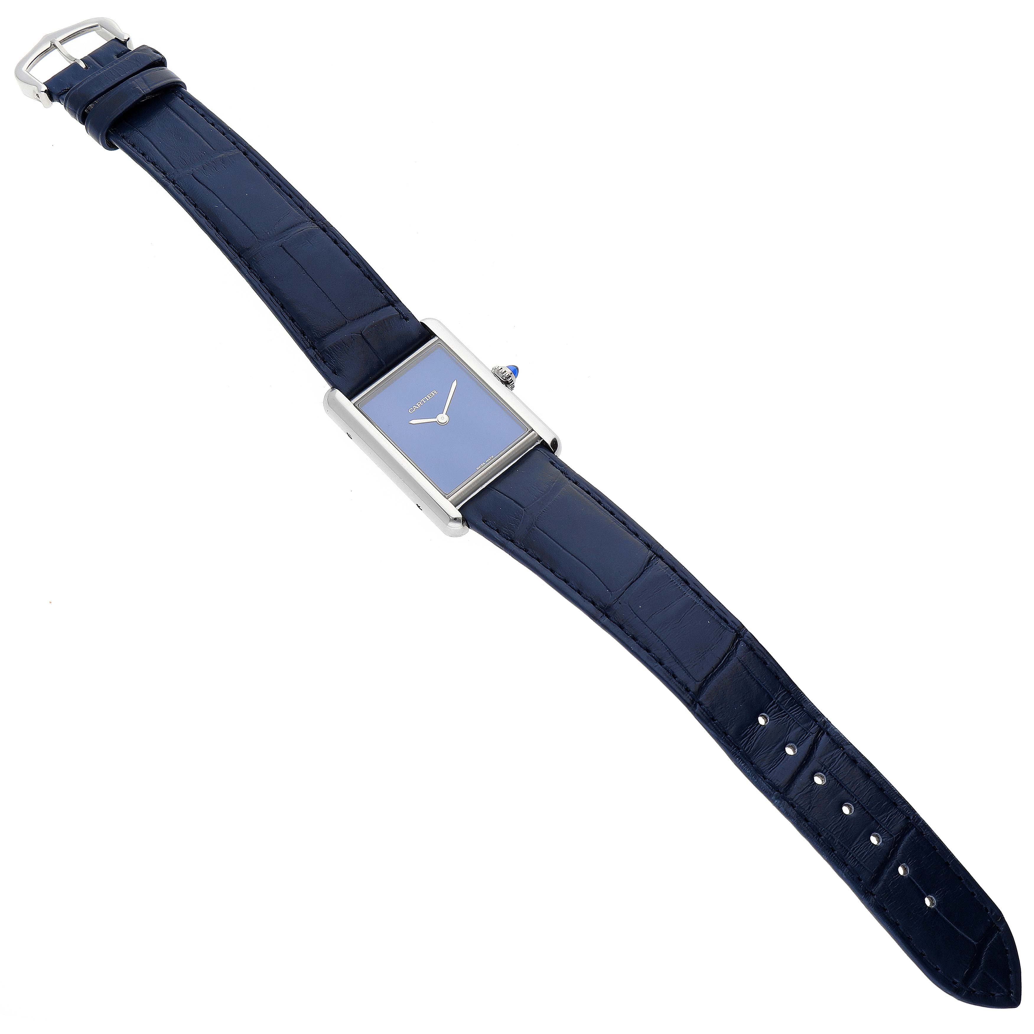 This image shows a Tank Must model by Cartier from a top-down angle, revealing its blue strap, rectangular face, and buckle.