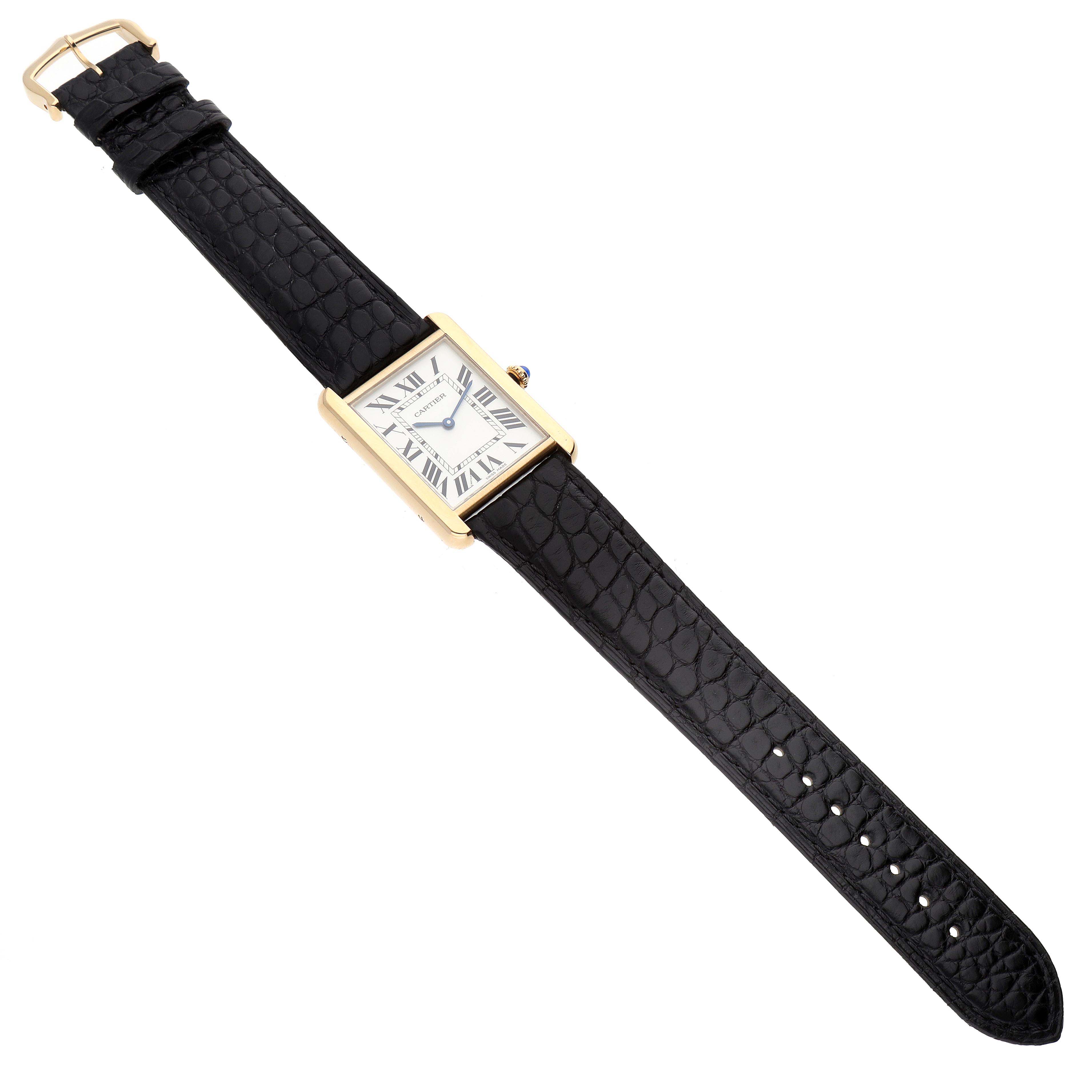 The image shows a Cartier Tank Solo W5200004 Men
s Steel and Gold (two tone) Silver Dial W5200004 Men
s Steel and Gold (two tone) Silver Dial watch, featuring a gold rectangular case, white dial, and black leather strap, laid flat.