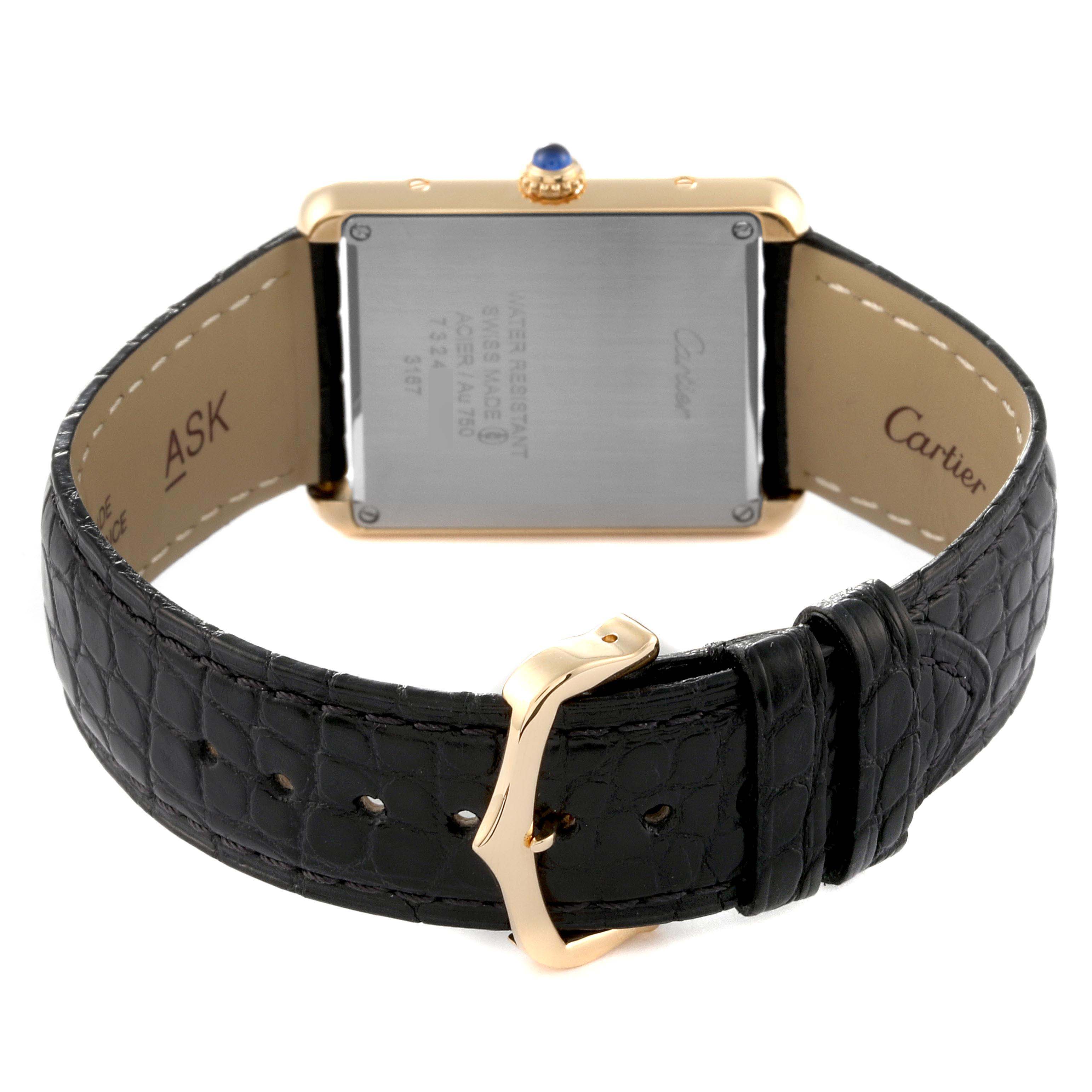 This image shows the back of the Cartier Tank Solo W5200004 Men
s Steel and Gold (two tone) Silver Dial W5200004 Men
s Steel and Gold (two tone) Silver Dial watch, including its case back, black leather strap, and gold buckle.