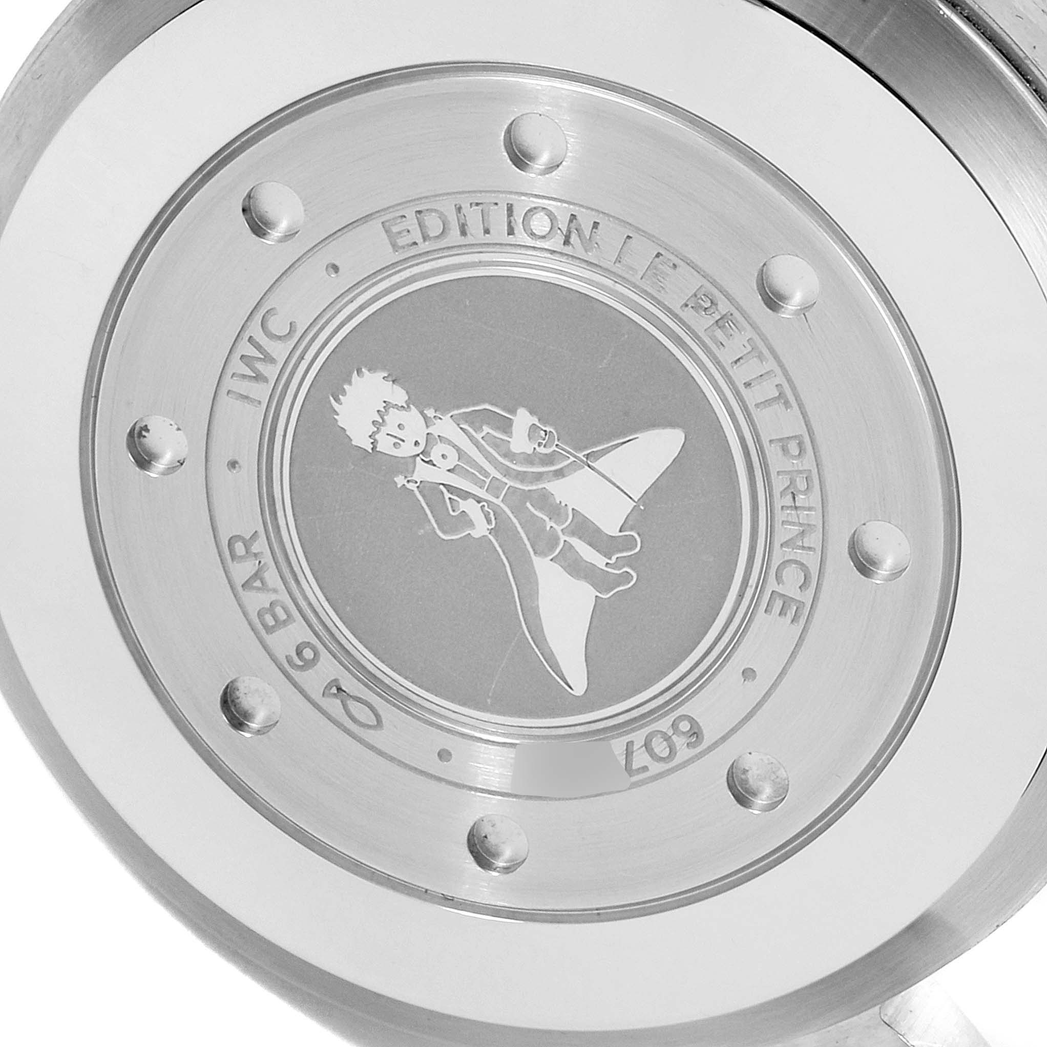 This image shows the back casing of an IWC Pilot IW500916 Men's Stainless Steel Blue Dial IW500916 Men's Stainless Steel Blue Dial model watch, displaying the "Edition Le Petit Prince" engravings and illustration.